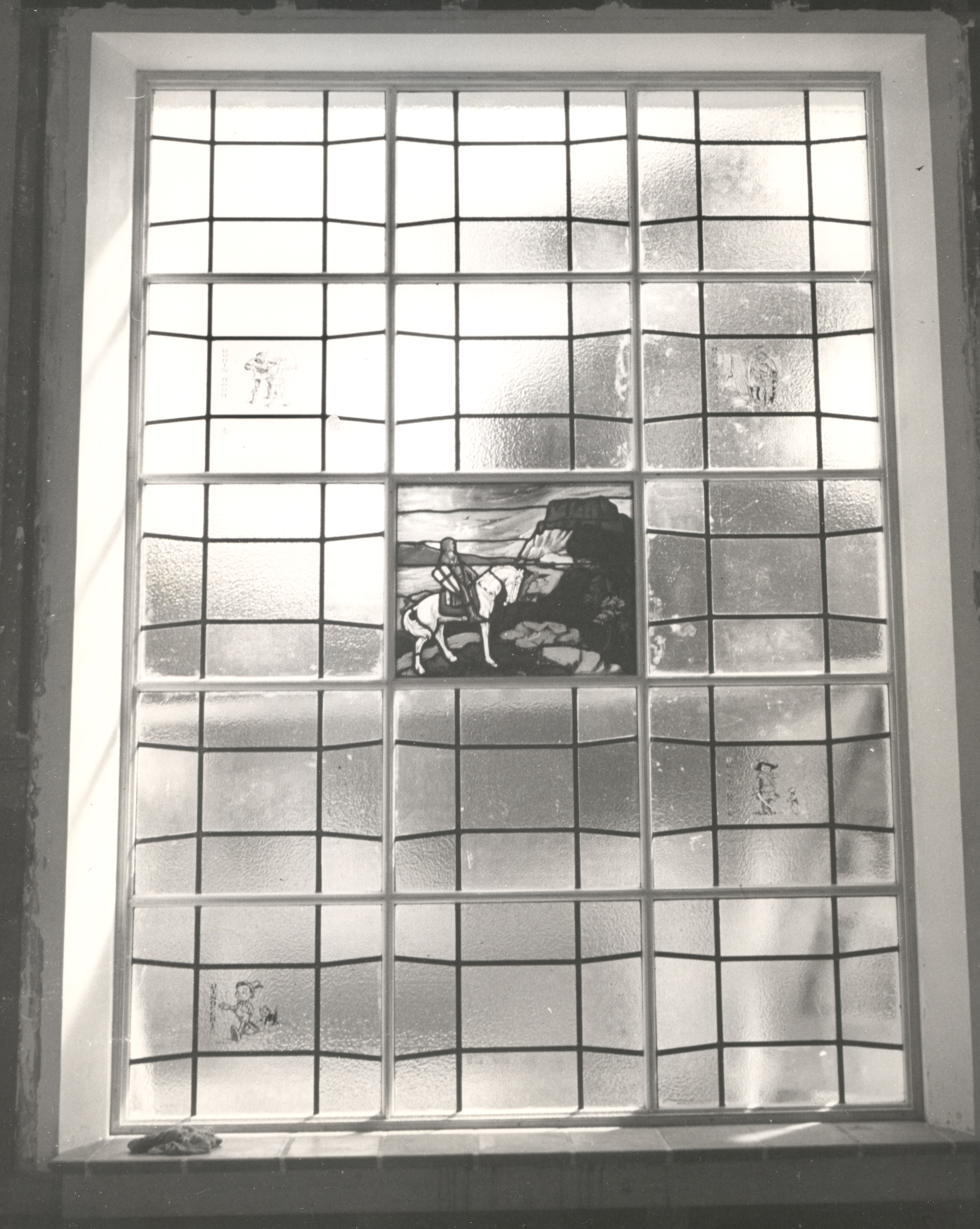 A black and white photograph of the Los Angeles-based Judson Studio stained and leaded glass inside the Fullerton Library.