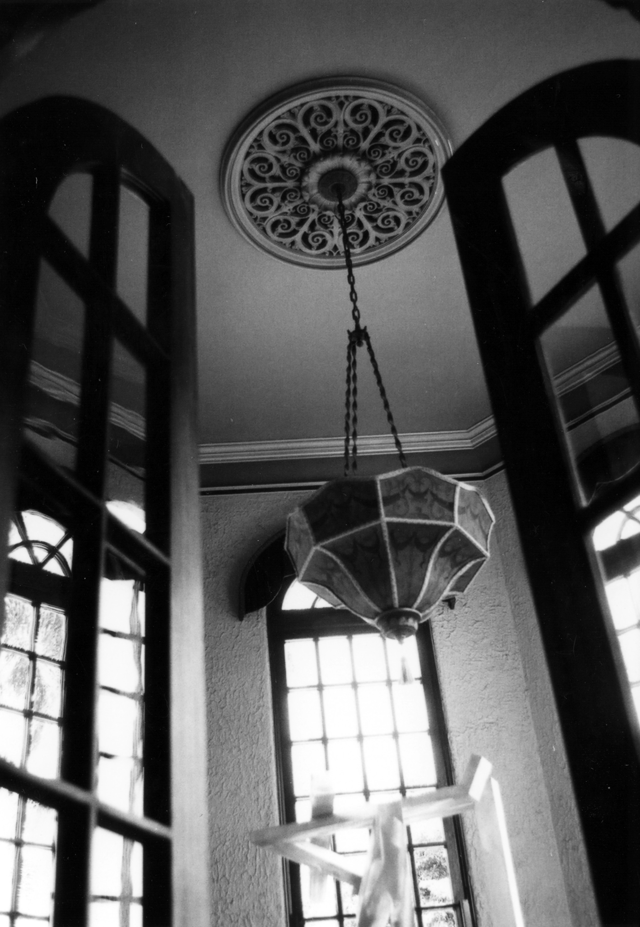 A black and white photograph of the original chandelier in the solarium of the Muckenthaler Estate, taken in 1978.