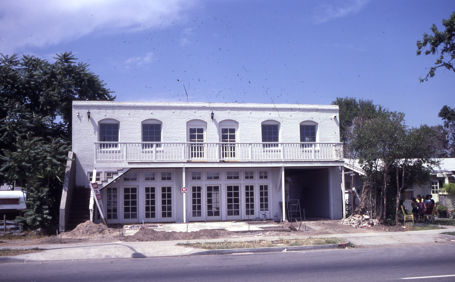 A colored photo of the exterior of Loumagne&#039;s Market during rehabilitation in 1984.