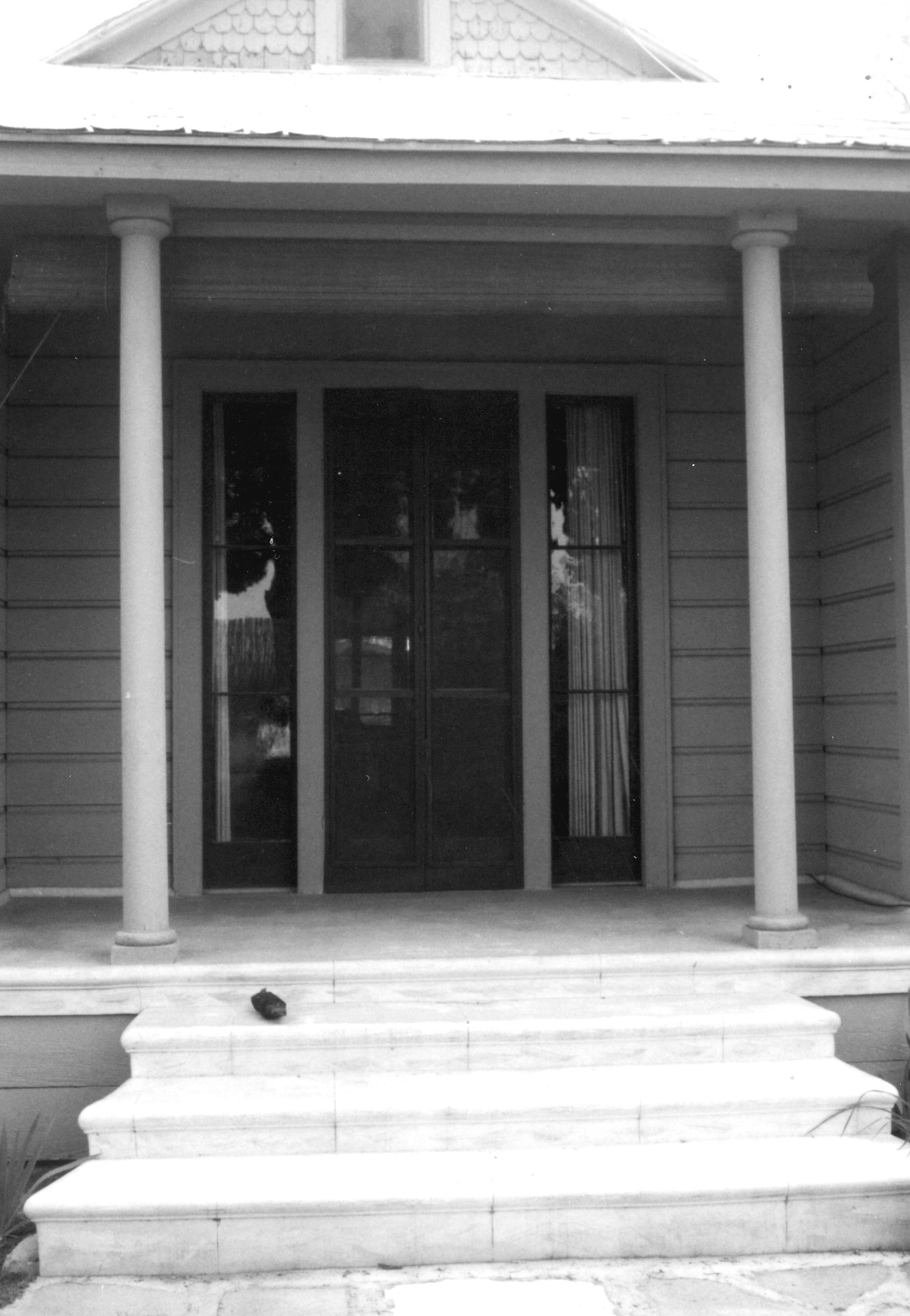 A black and white photograph of the front entrance of the Otto Des Granges House in 1967.