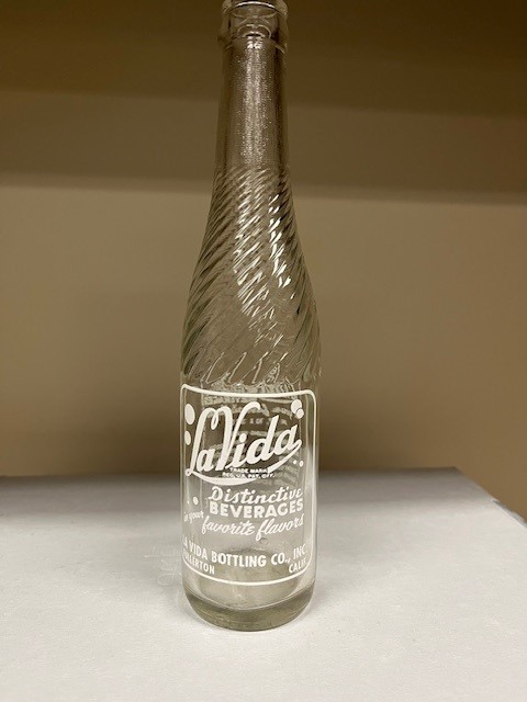 A colored photograph of a LaVida bottle from the La Vida Bottling Company.