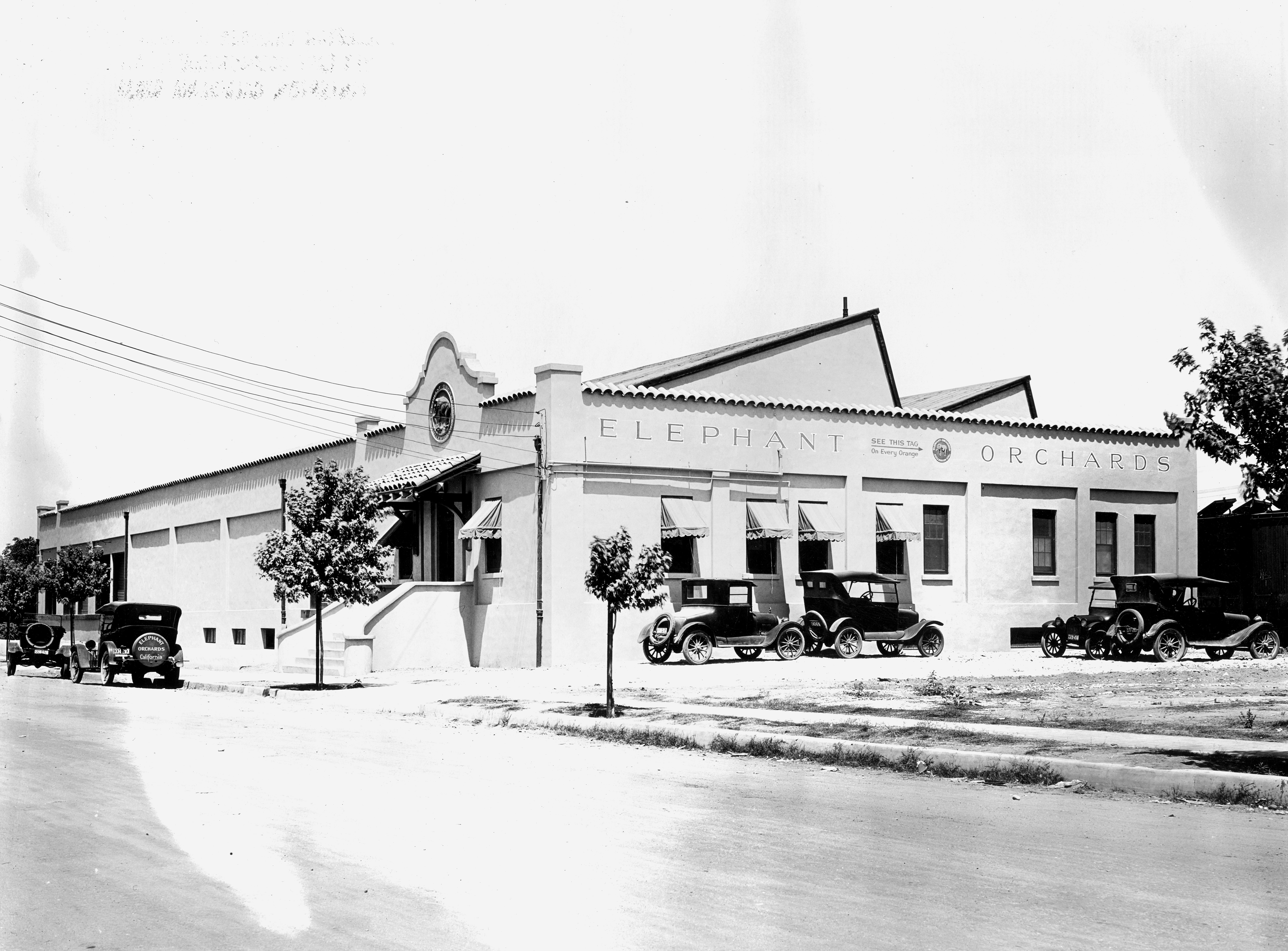 A black and white photograph of the early exterior of the Elephant Packing House in 1927.