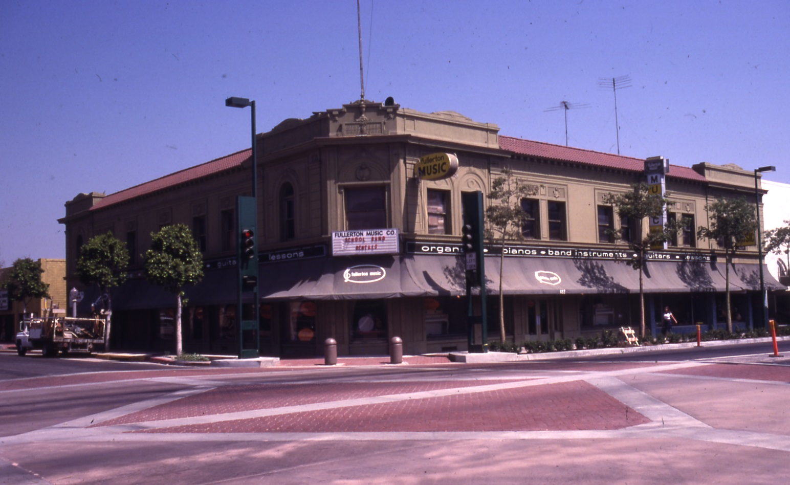 A colored photo of the Farmers and Merchants Bank during Fullerton Music in 1981.