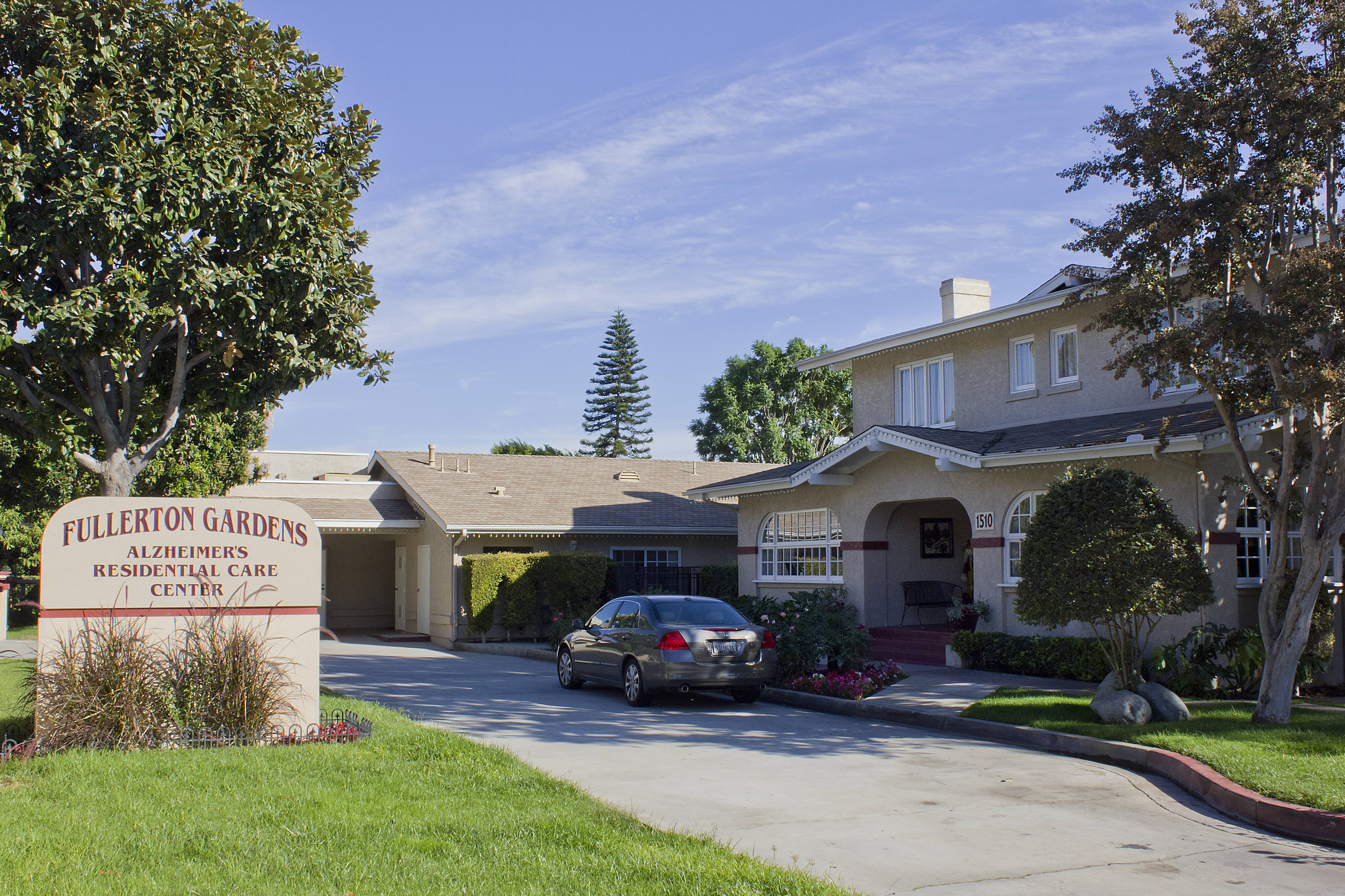 A colored photo of the Bert Annin House as a residential care center in 2012. The sign in front of the property reads: Fullerton Gardens. Alzheimer&#039;s Residential Care Center.