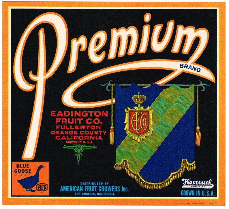 A colored photo of the Eadington Citrus Label. The photo reads: Premium Brand. Eadington Fruit Co. Fullerton, Orange County, California. Grown in U.S.A. Distributed by American Fruit Growers Inc. Los Angeles, California. Flavorseal Protected. Grown in U.S.A.