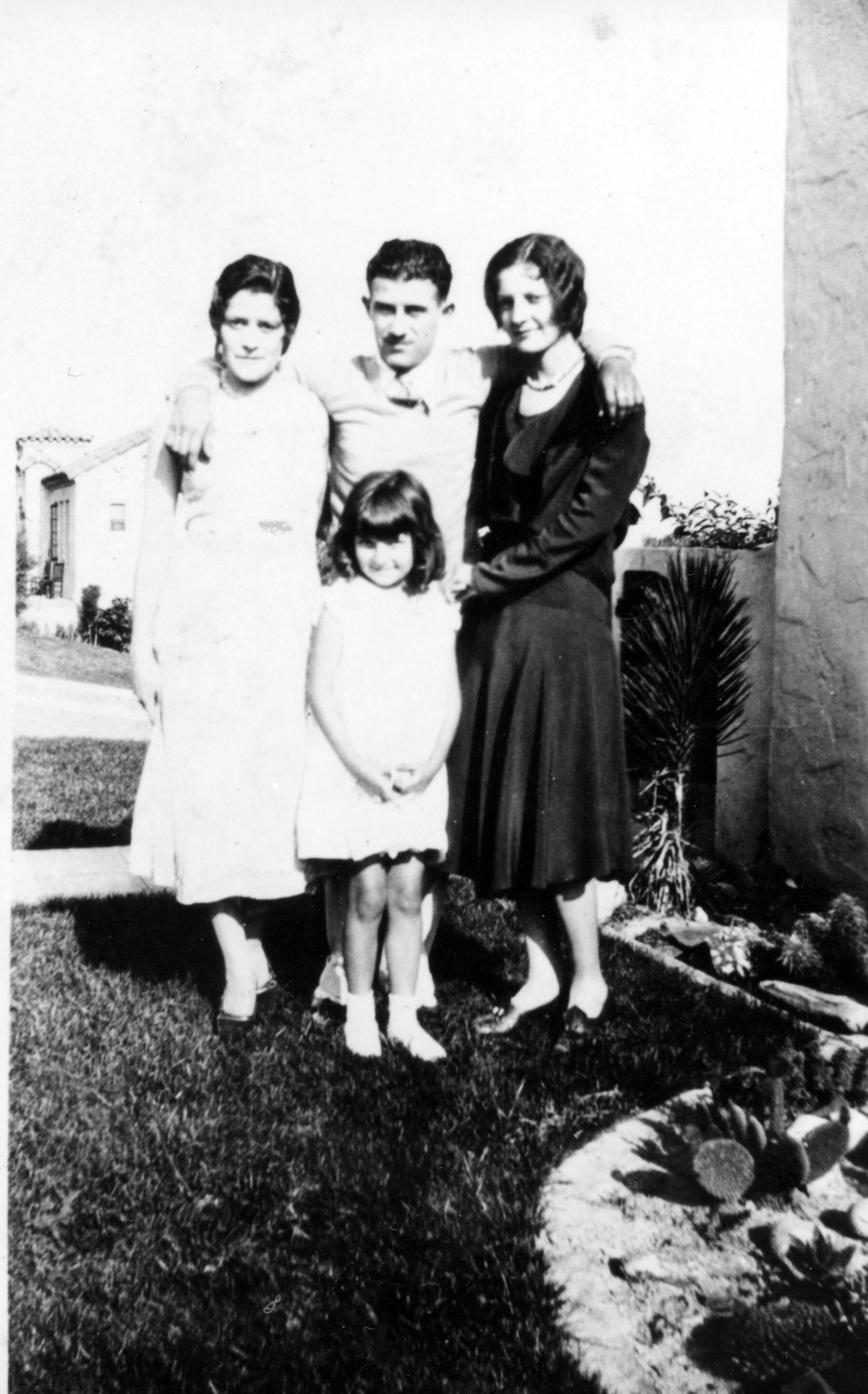A black and white photograph of the Hirigoyen family standing on the lawn in the 1940s.