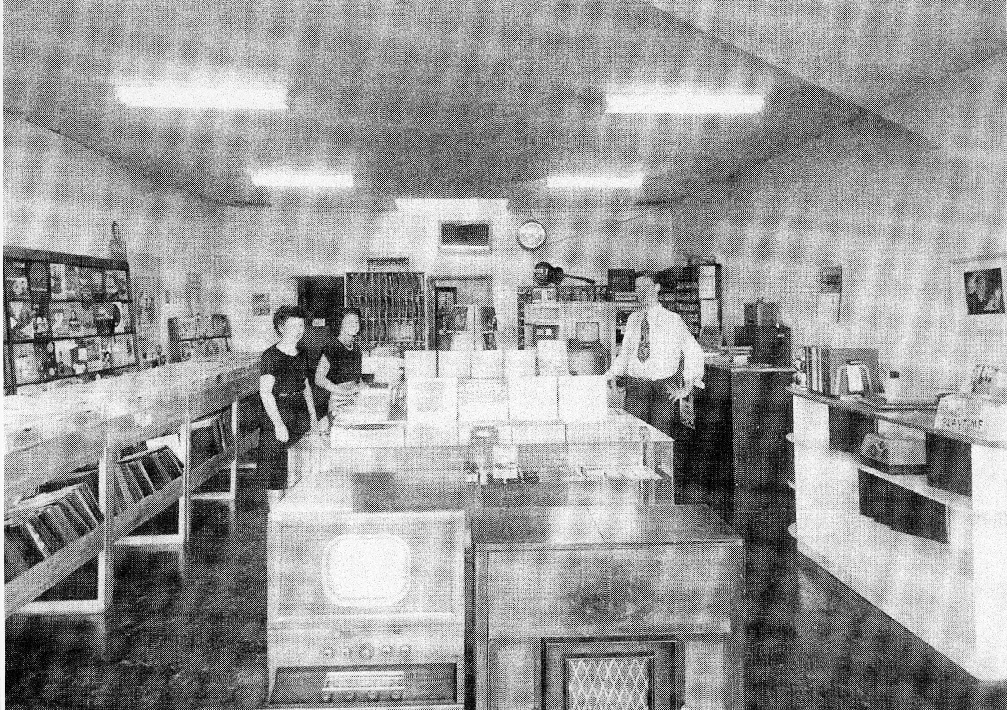 A black and white photograph of the shop interior for the Leo Fender Radio Shop in 1949.