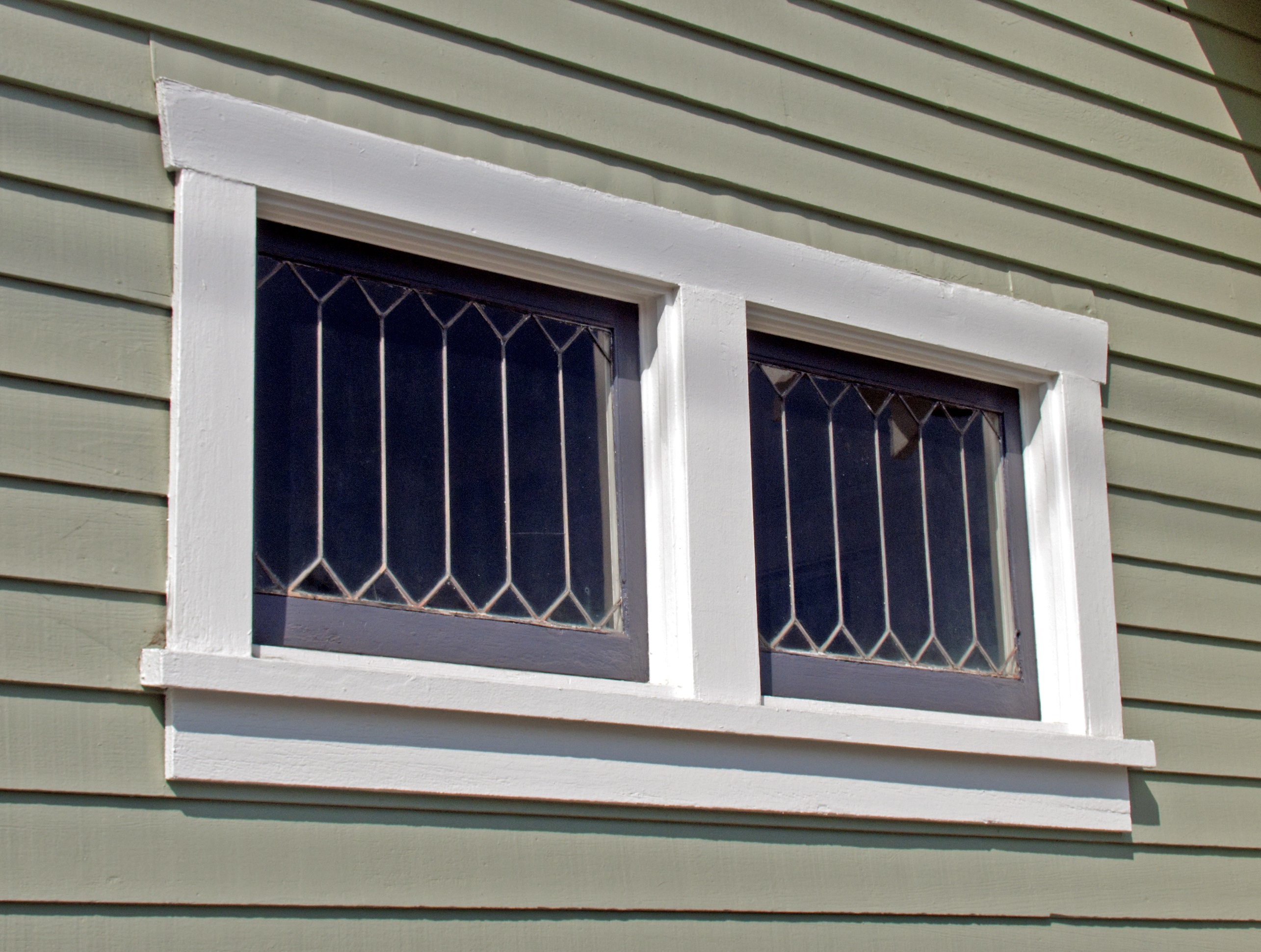 A colored photo of the window detail of the Henry Burdorf House in 2012.