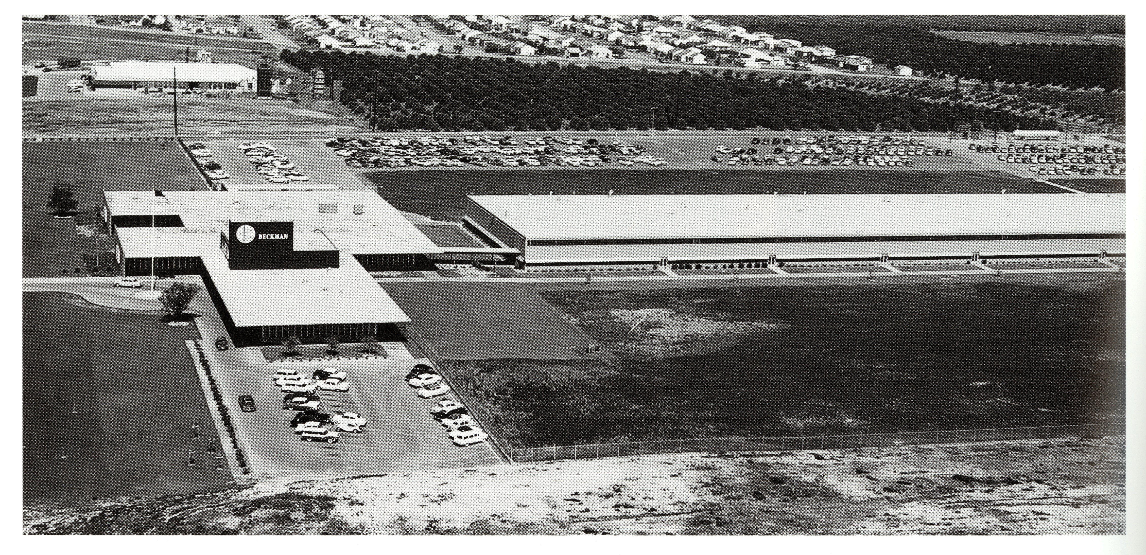 A black and white aerial view photograph of the Beckman Instruments Administration Building.