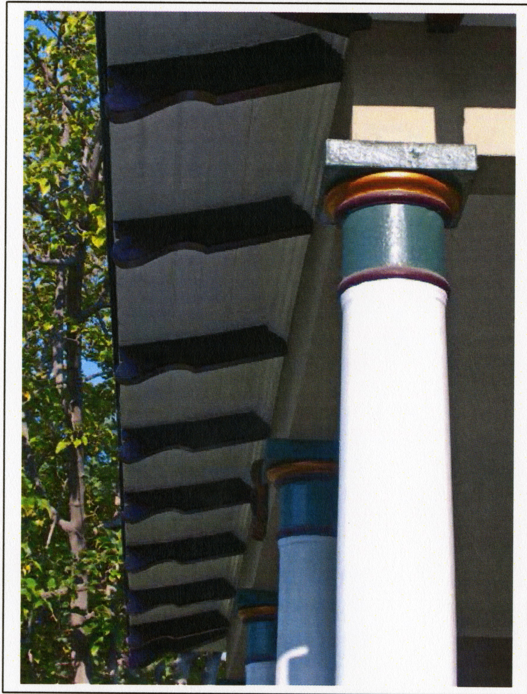 A colored photo of the column and eave detailing of the Herman Russell House in 2015.