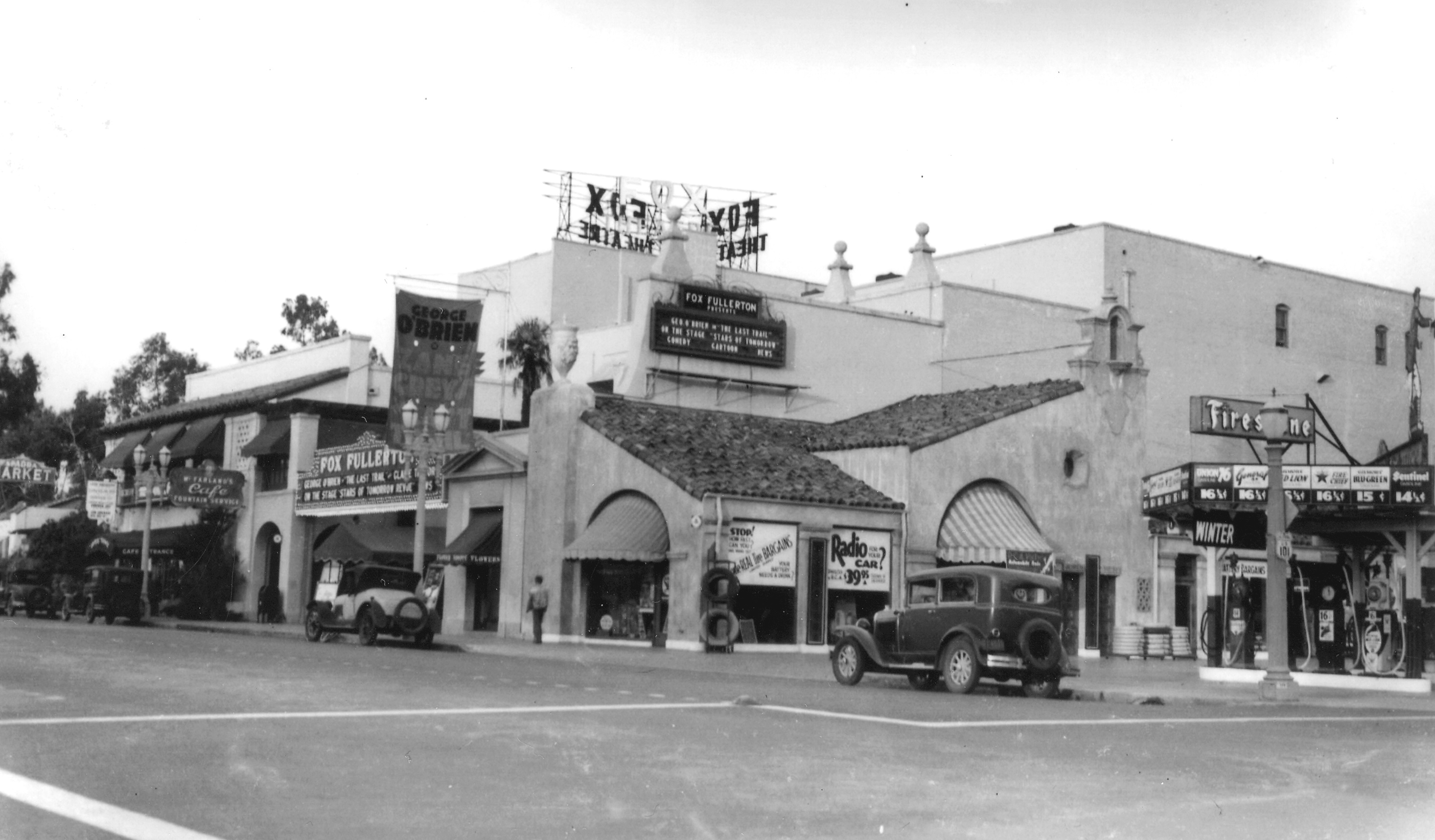 A black and white photograph of the exterior of the Firestone Tire Service Building in 1927.