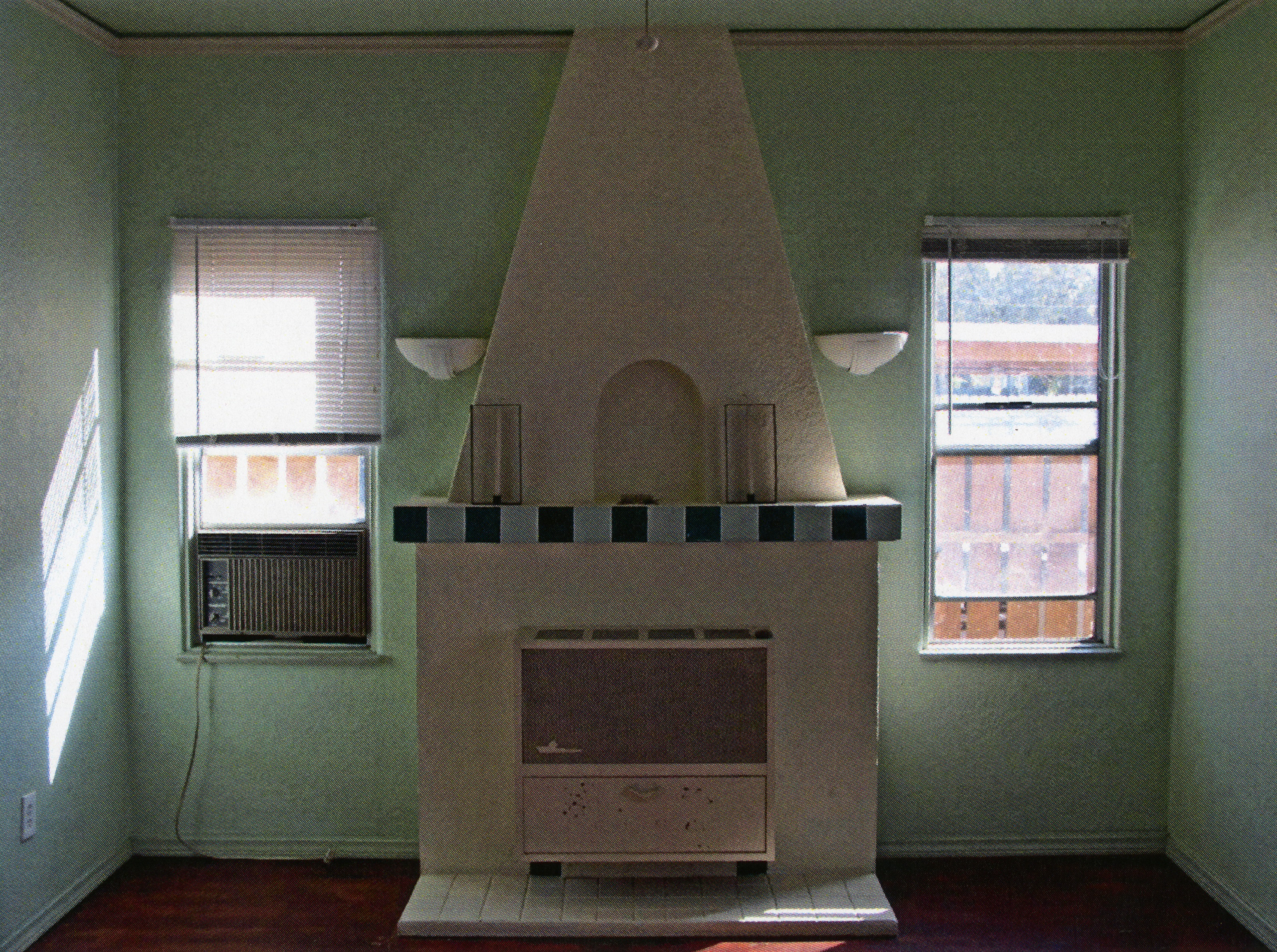 A colored photo of the false fireplace inside the Fred Carter Apartment House in 2014.