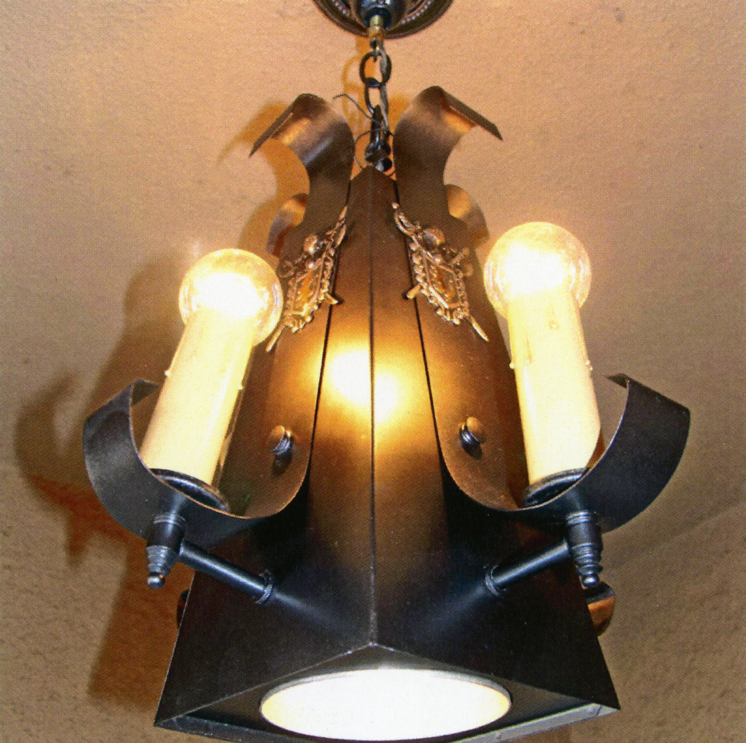 A colored photo of the restored original porch light for the Fred Carter Apartment House in 2014.