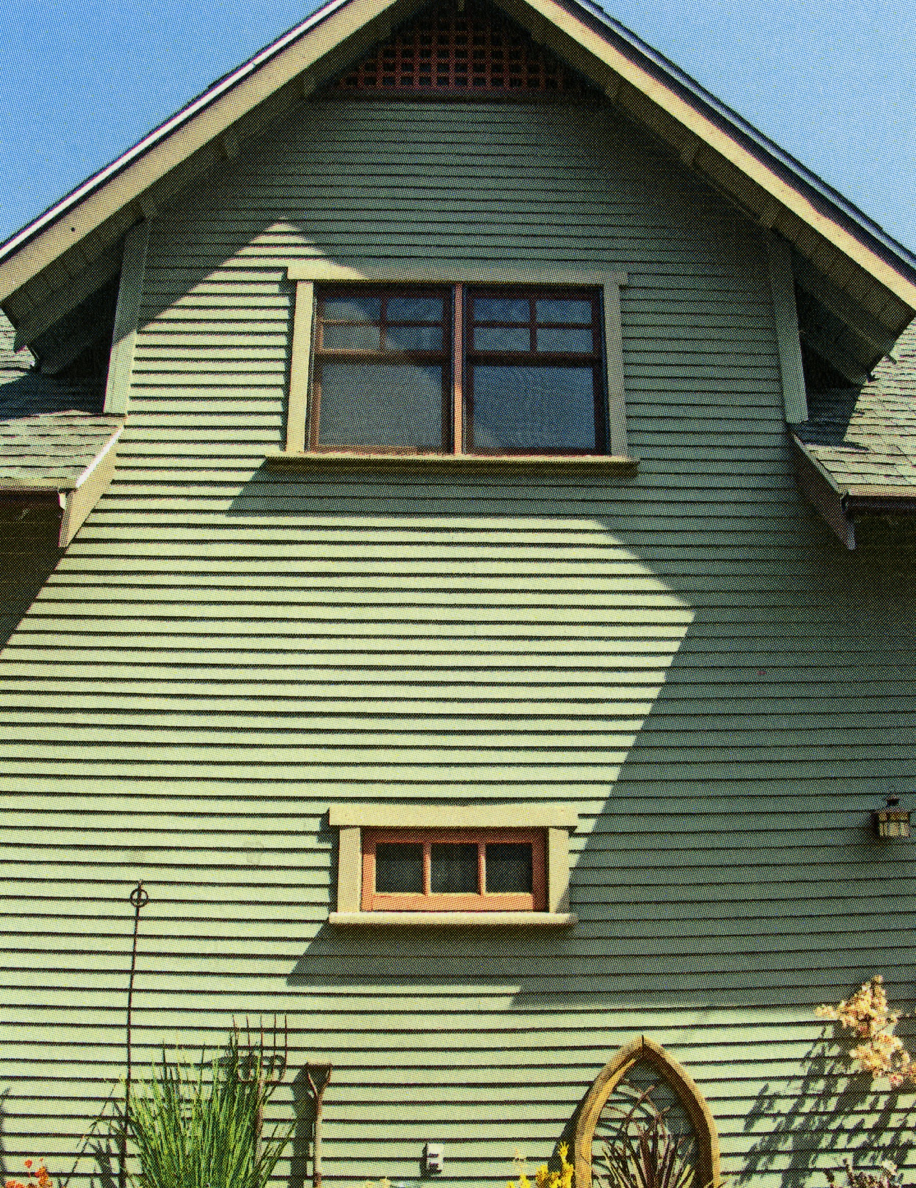 A colored photo of the two-story garage and office of the Julius Bradford House in 2013.