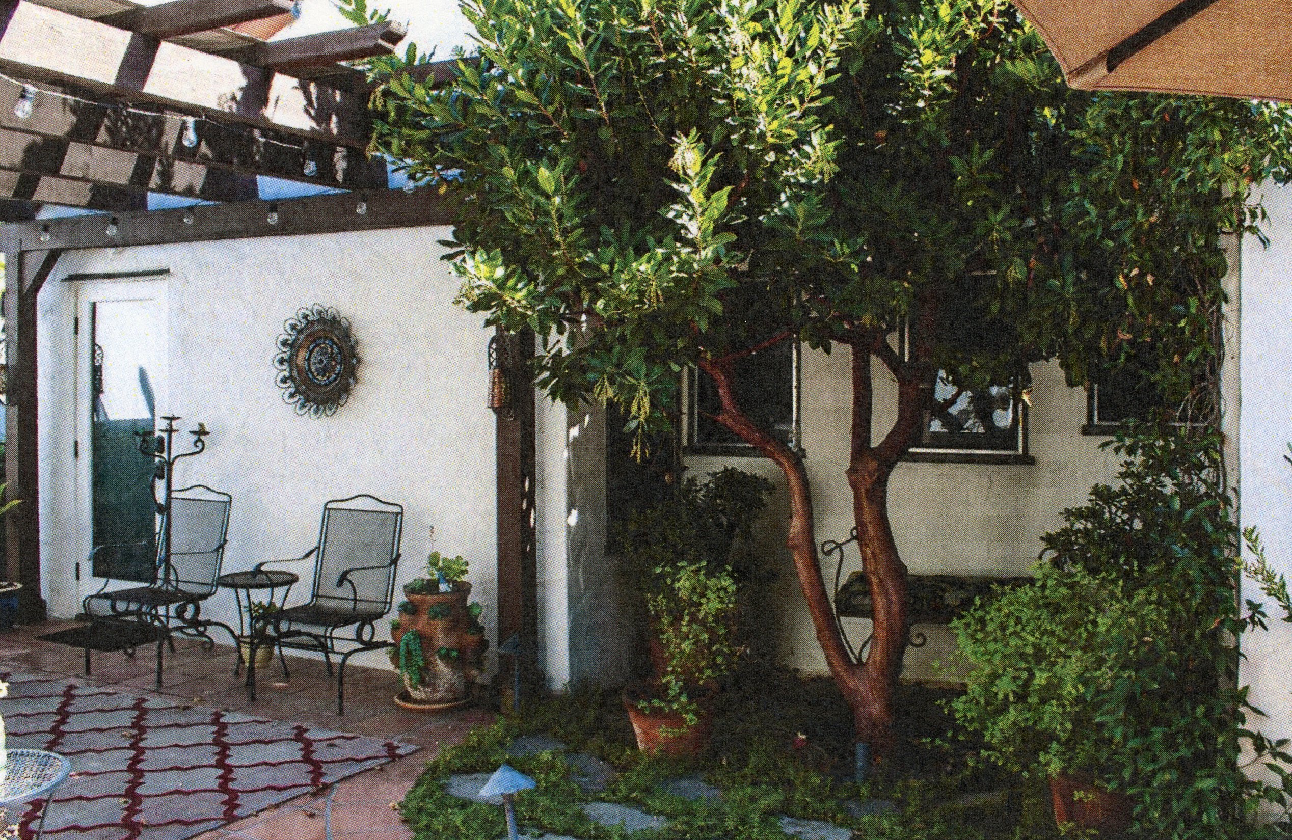 A colored photo of the back patio of the Harry Suters House in 2024.