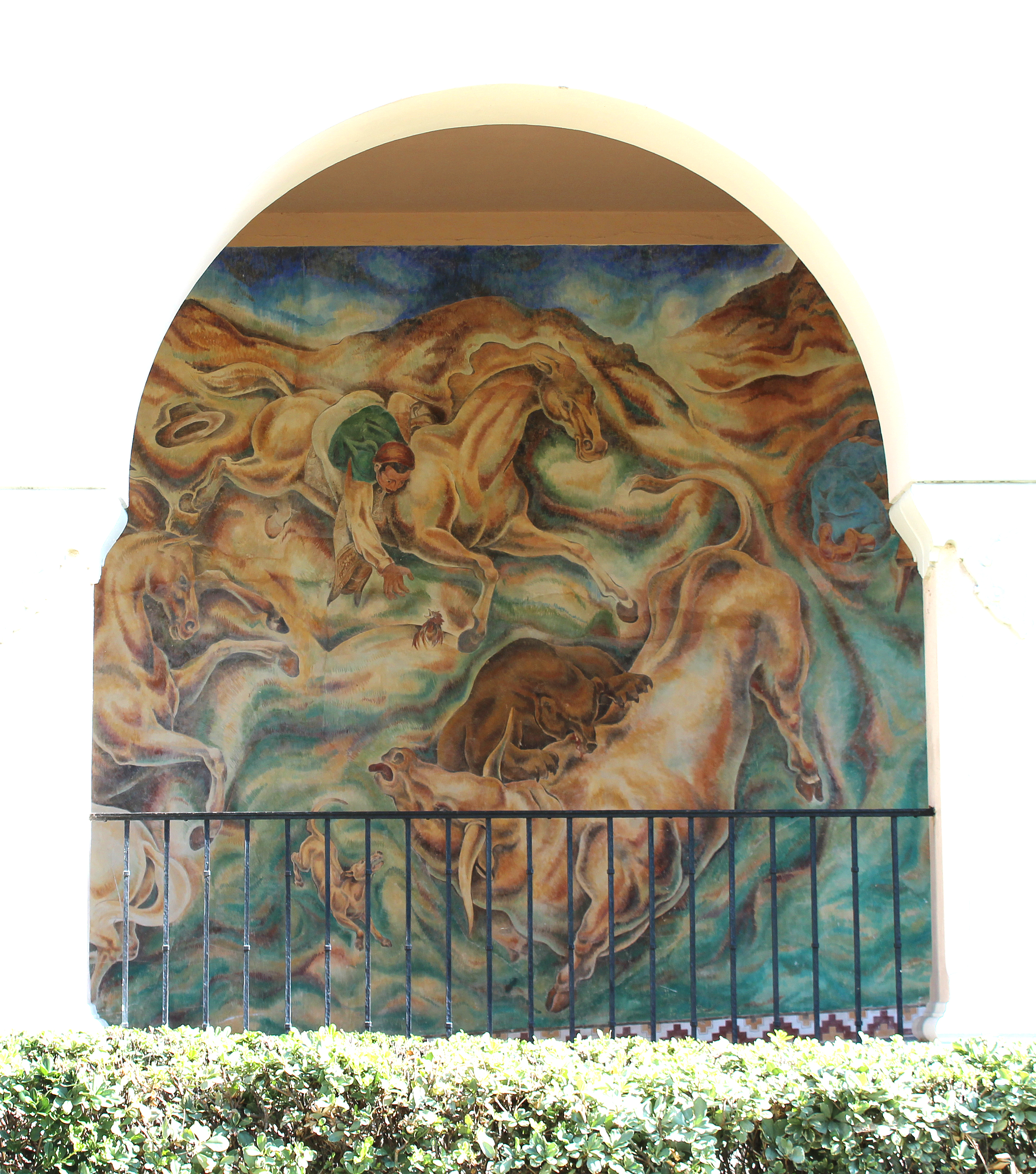 A colored photo of the fresco panel of the &quot;Pastoral California&quot; Mural seen through the arcade in 2021.