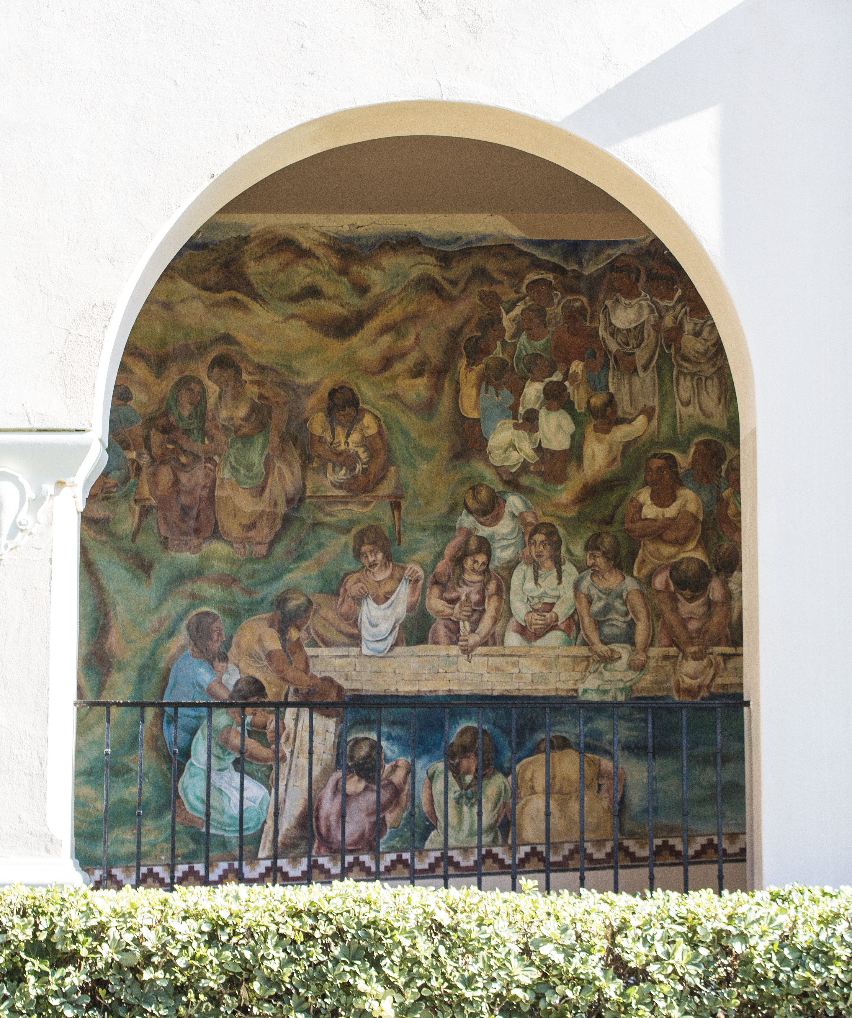 A colored photo of the fresco panel of the &quot;Pastoral California&quot; Mural seen through the arcade in 2021.