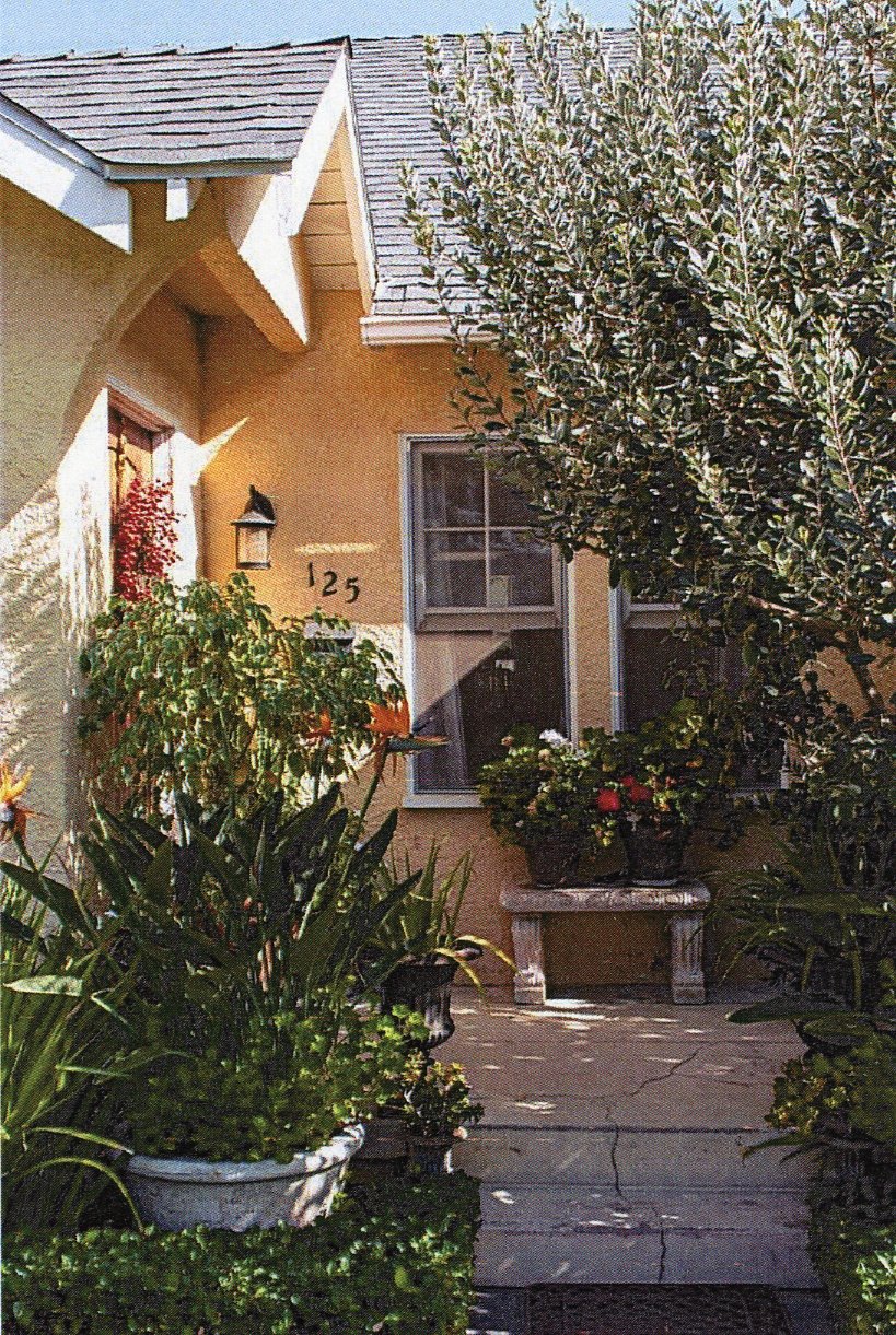 A colored photo of the front porch of the Dell Trook House in 2023.