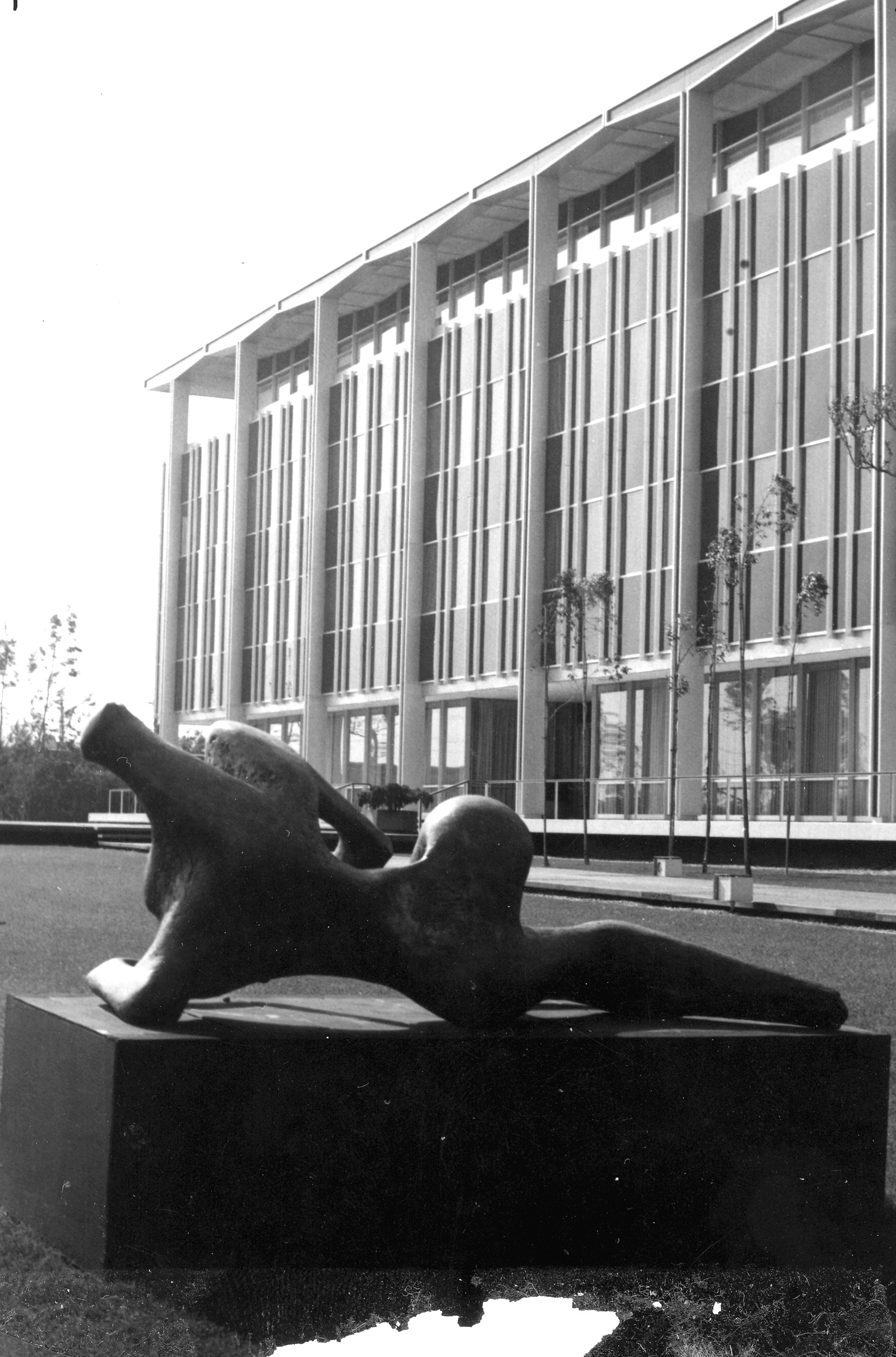 A black and white photograph of the Hunt Headquarters with a sculpture located outside of the building.