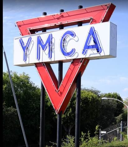 A colored photo of the YMCA neon sign during the day in 2019.