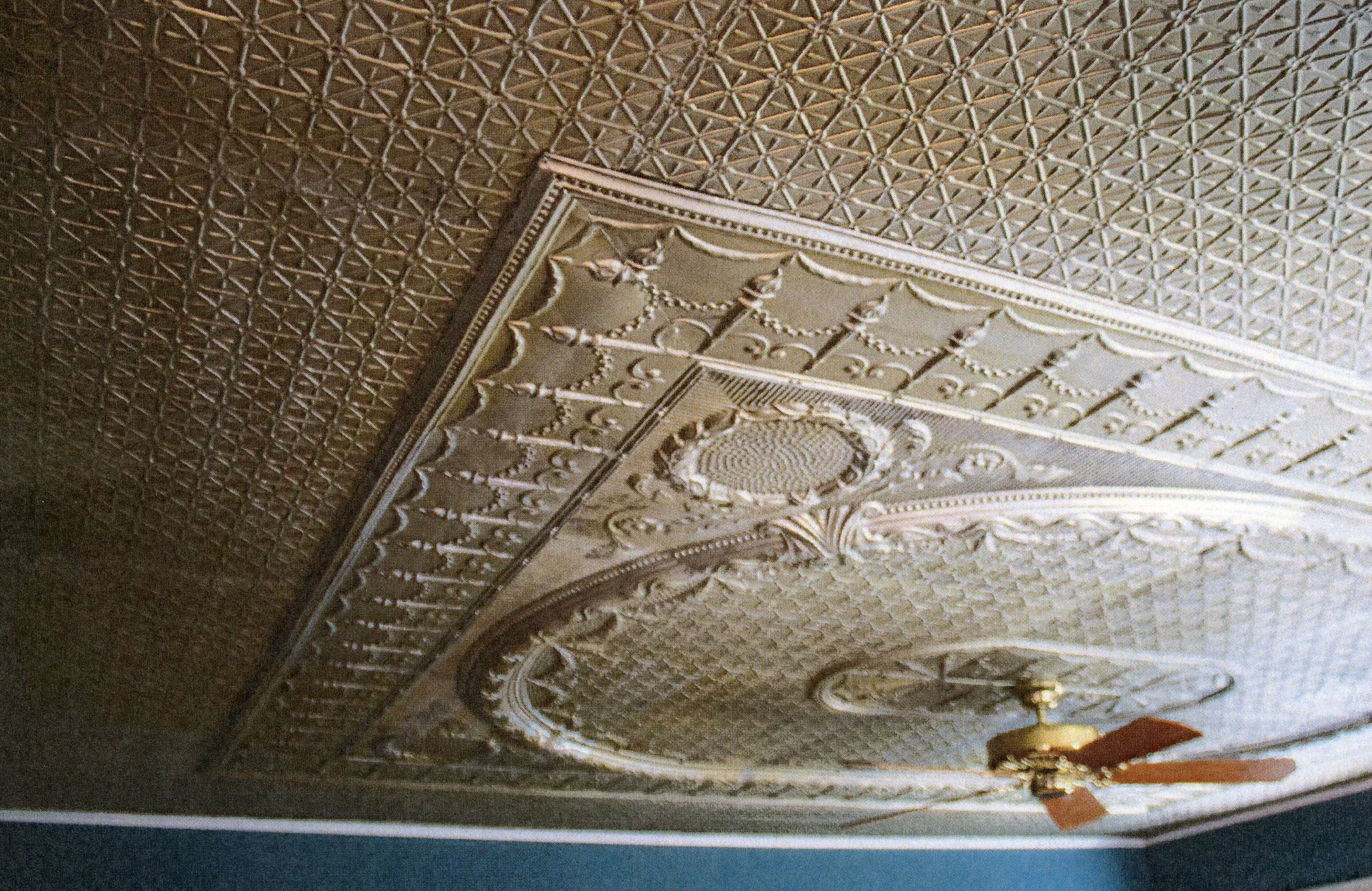A colored photo of the original tin ceiling inside the James Naylor - Tom &amp; Kate Dalton House in 2019.