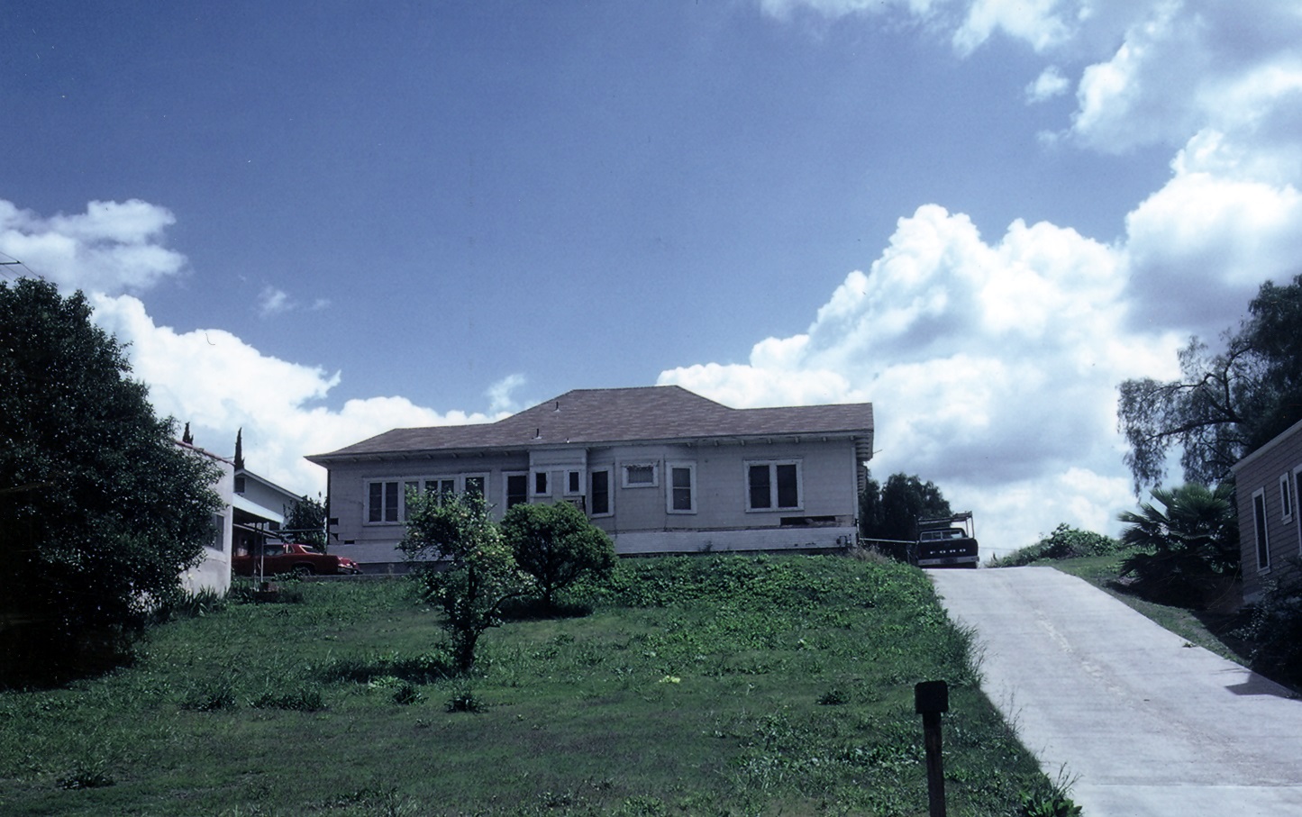 A colored photo of the side view of the Meredith Conway House after being relocated to Marion Boulevard in 1980.