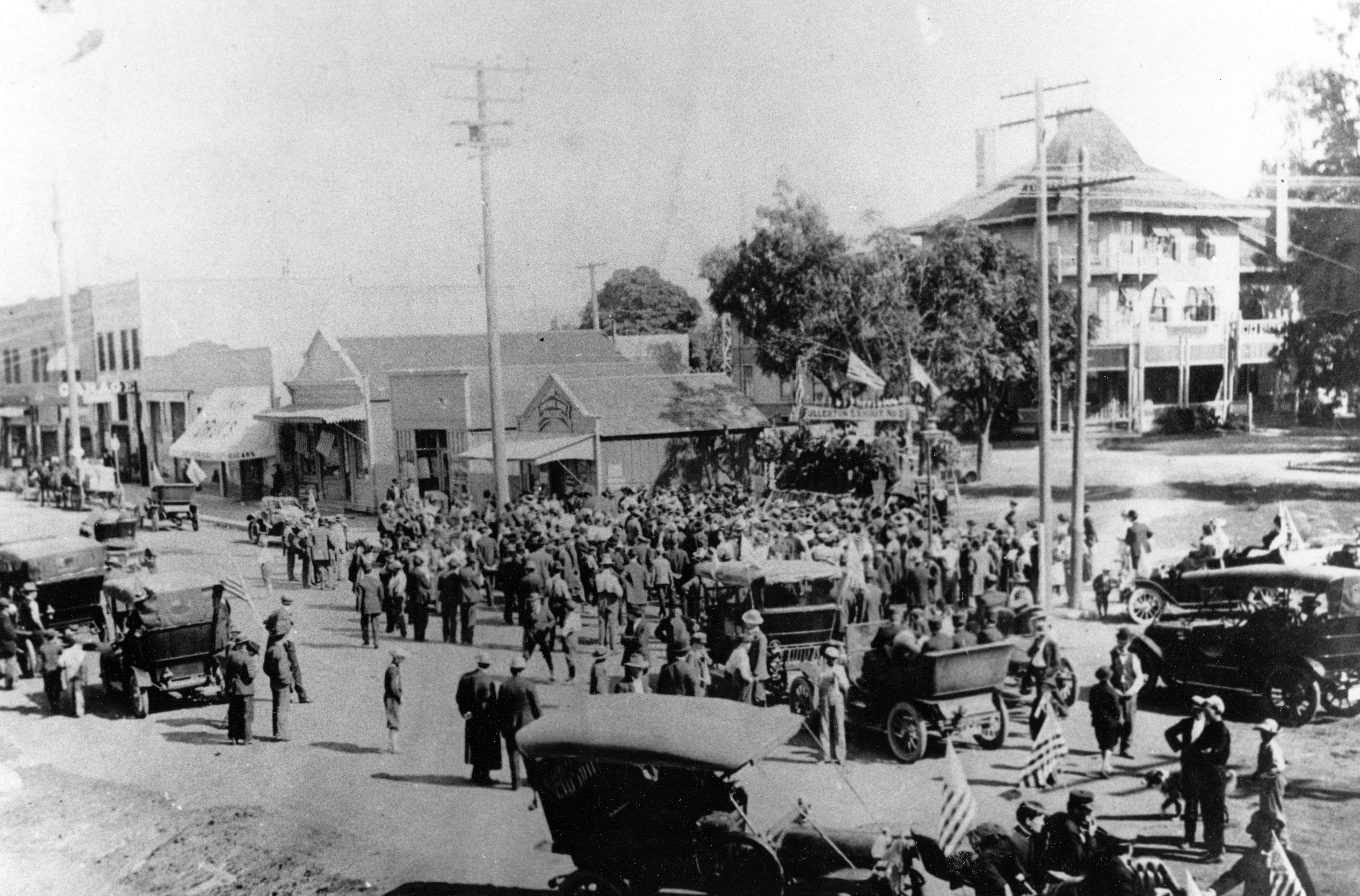 A black and white photograph of a busy street scene with the Amerige Office in the center.