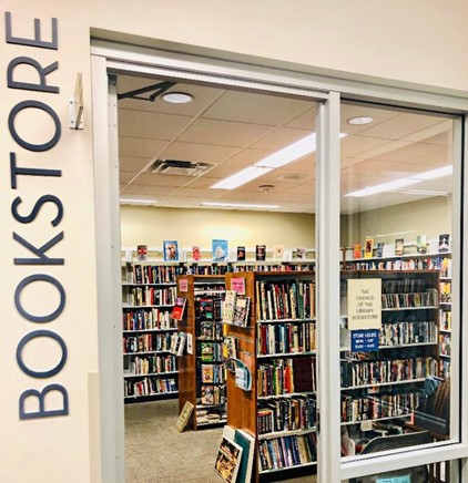 Photograph that looks through the open door of the Friends bookstore and welcomes library patrons to browse