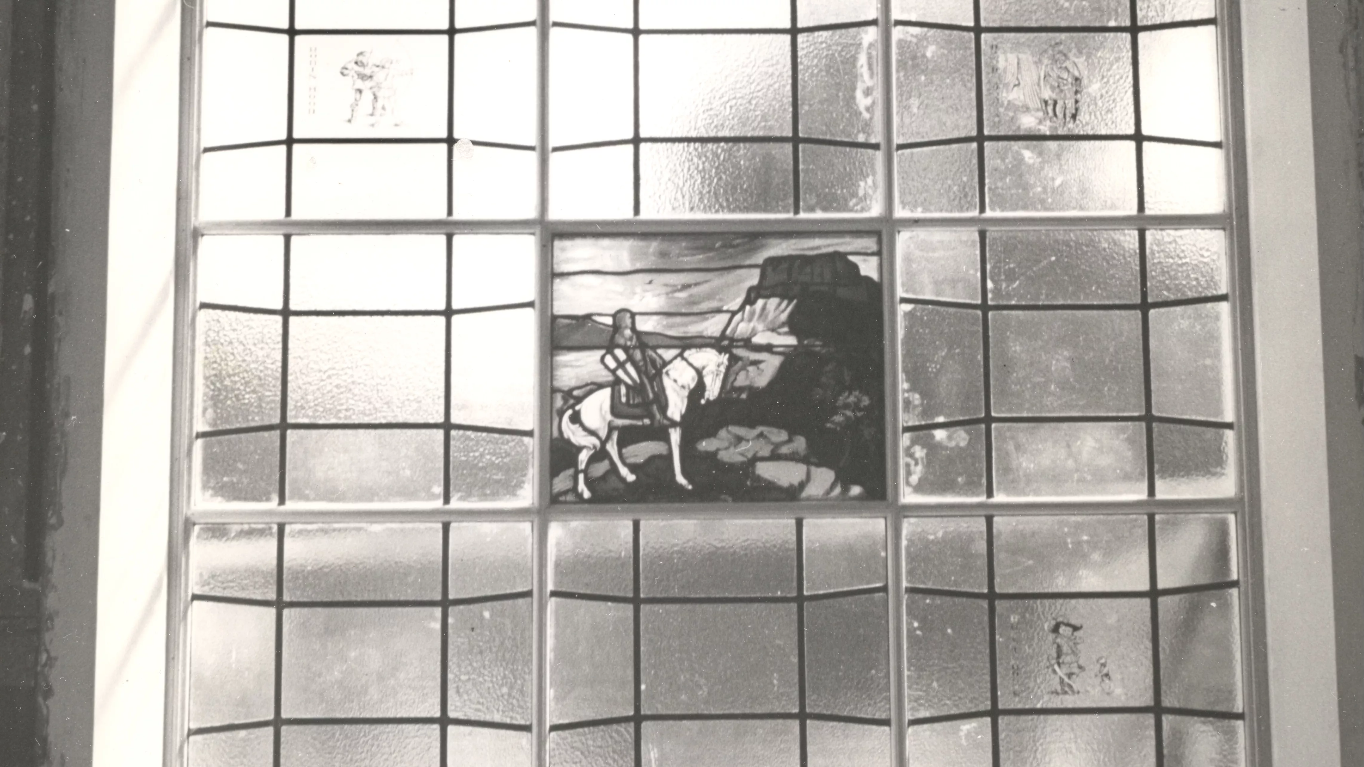 A black and white photograph of the Los Angeles-based Judson Studio stained and leaded glass inside the Fullerton Library.