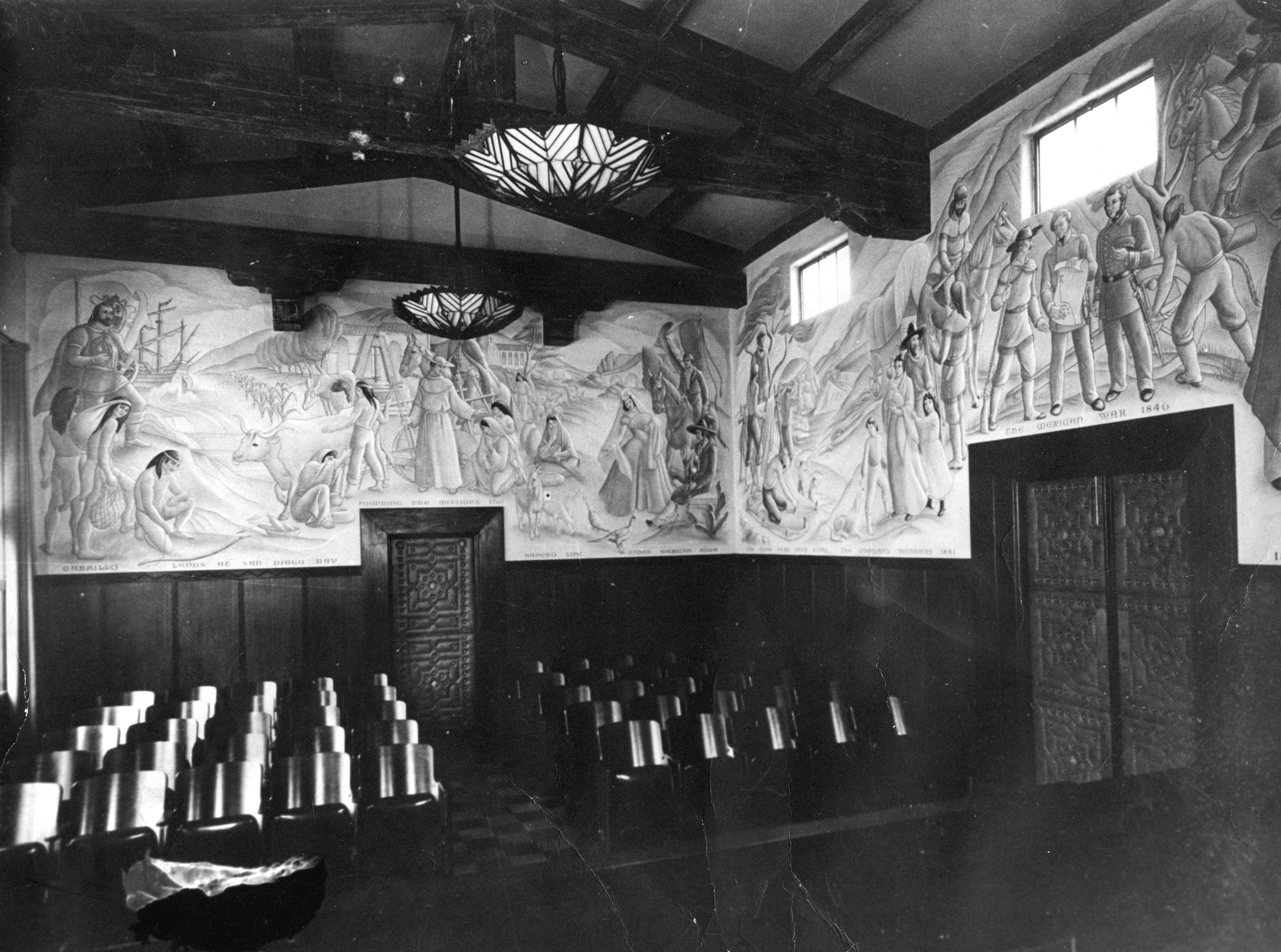 A black and white photograph of the Lundeburg murals in the City Council Chambers.