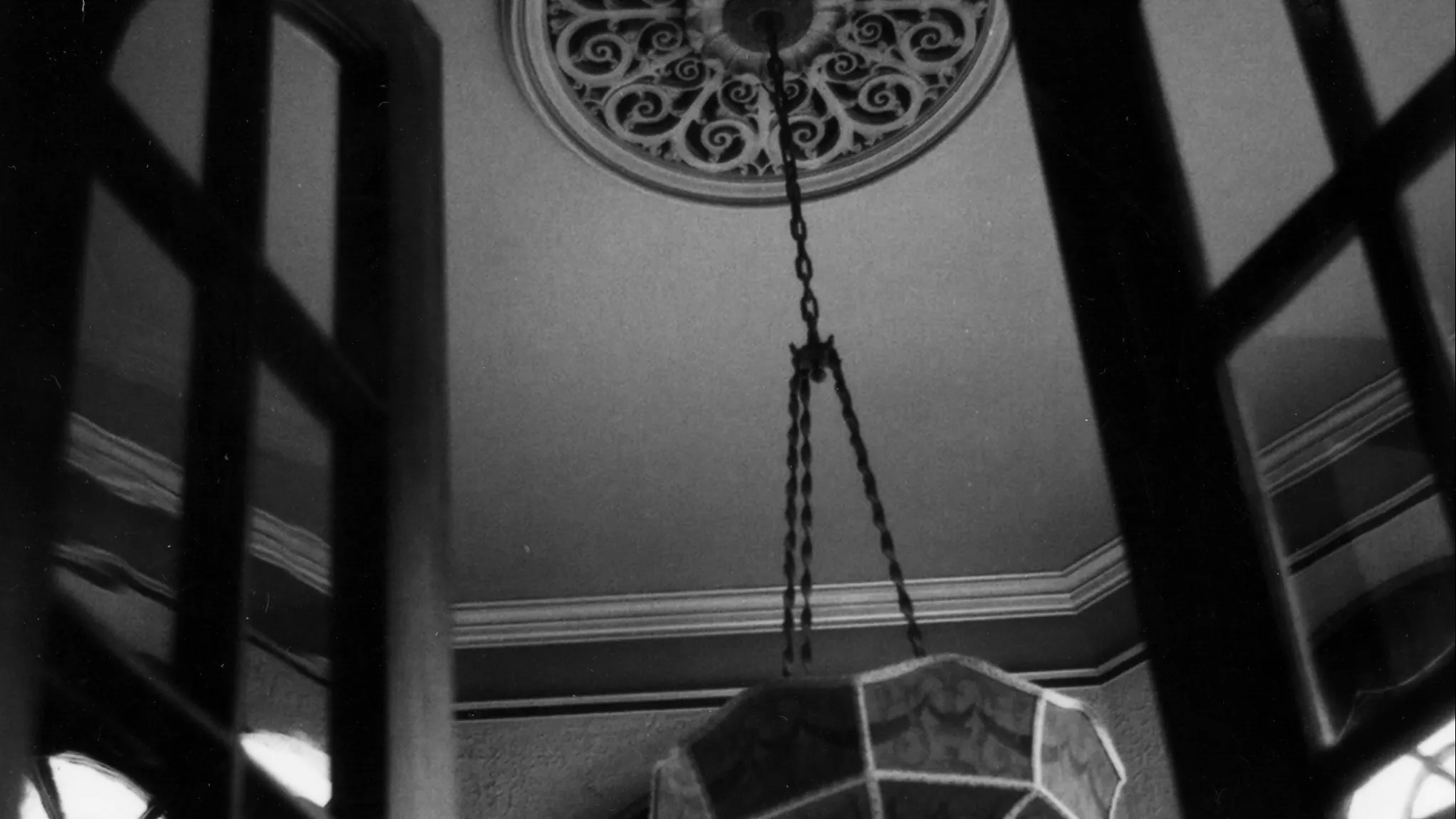 A black and white photograph of the original chandelier in the solarium of the Muckenthaler Estate, taken in 1978.