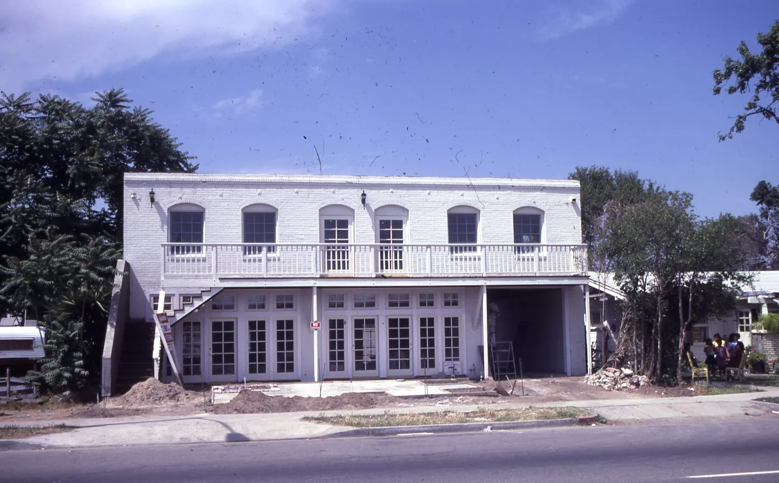 A colored photo of the exterior of Loumagne&#039;s Market during rehabilitation in 1984.