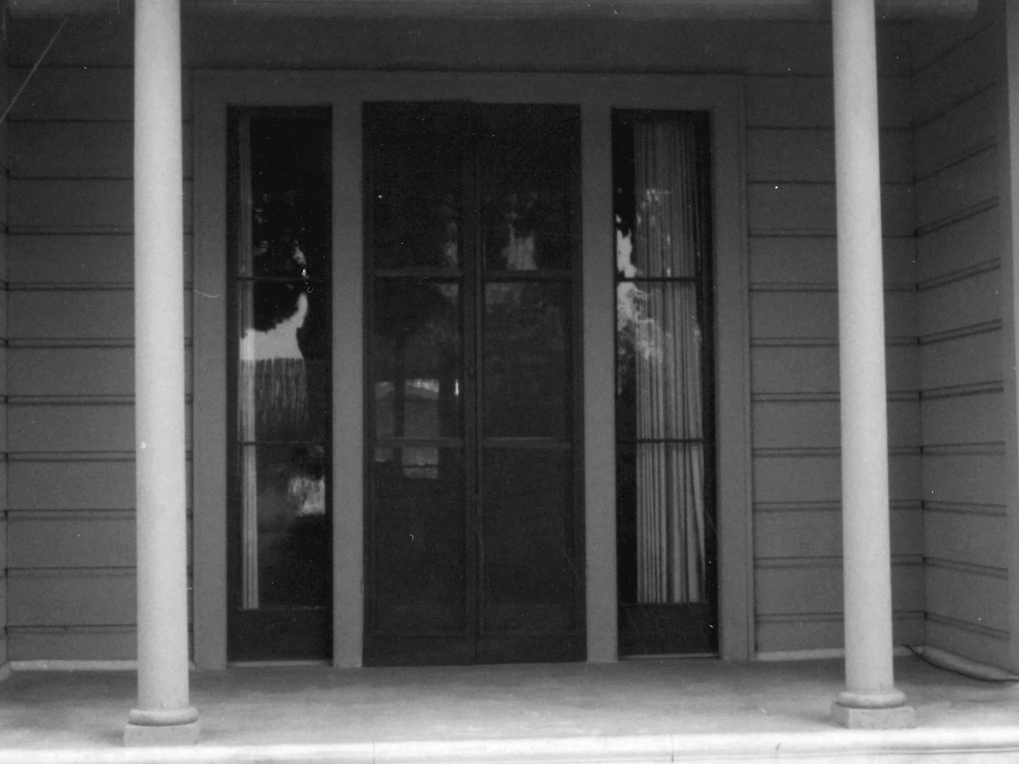 A black and white photograph of the front entrance of the Otto Des Granges House in 1967.
