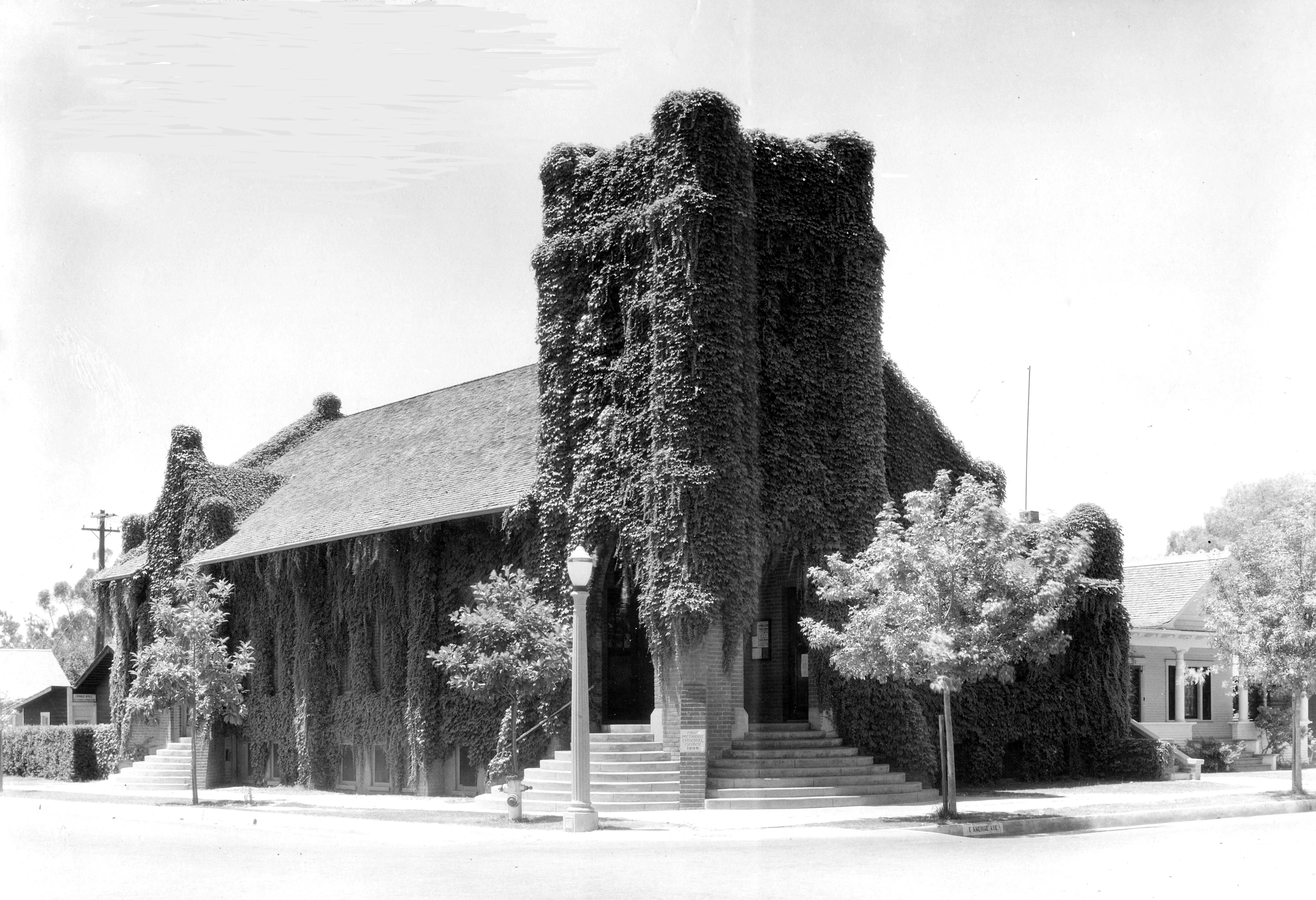 A black and white photograph of the Methodist Church and Parsonage in 1927.