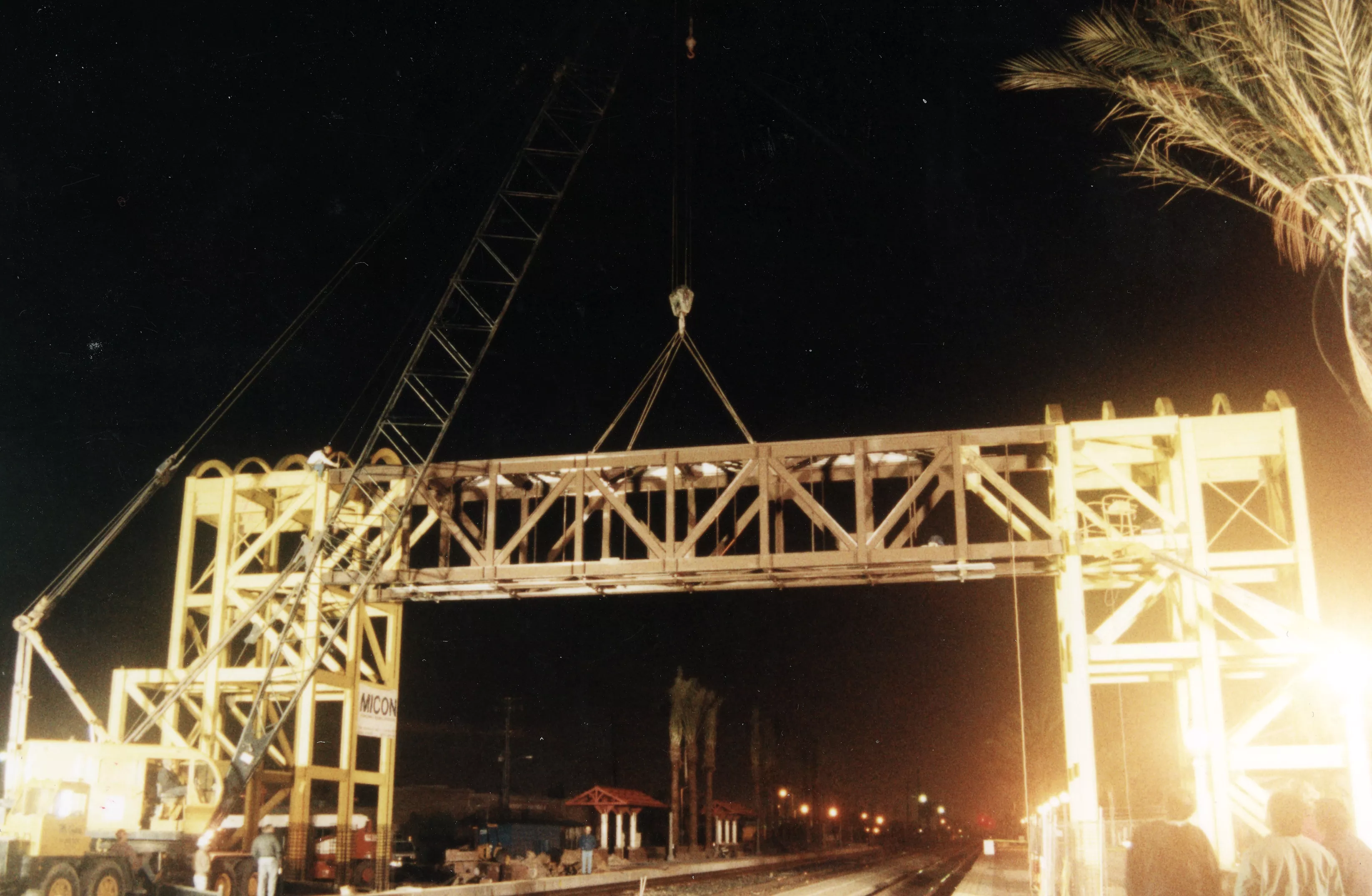 A colored photo of the construction of the pedestrian bridge for the Santa Fe Railway Passenger &amp; Freight Depot.