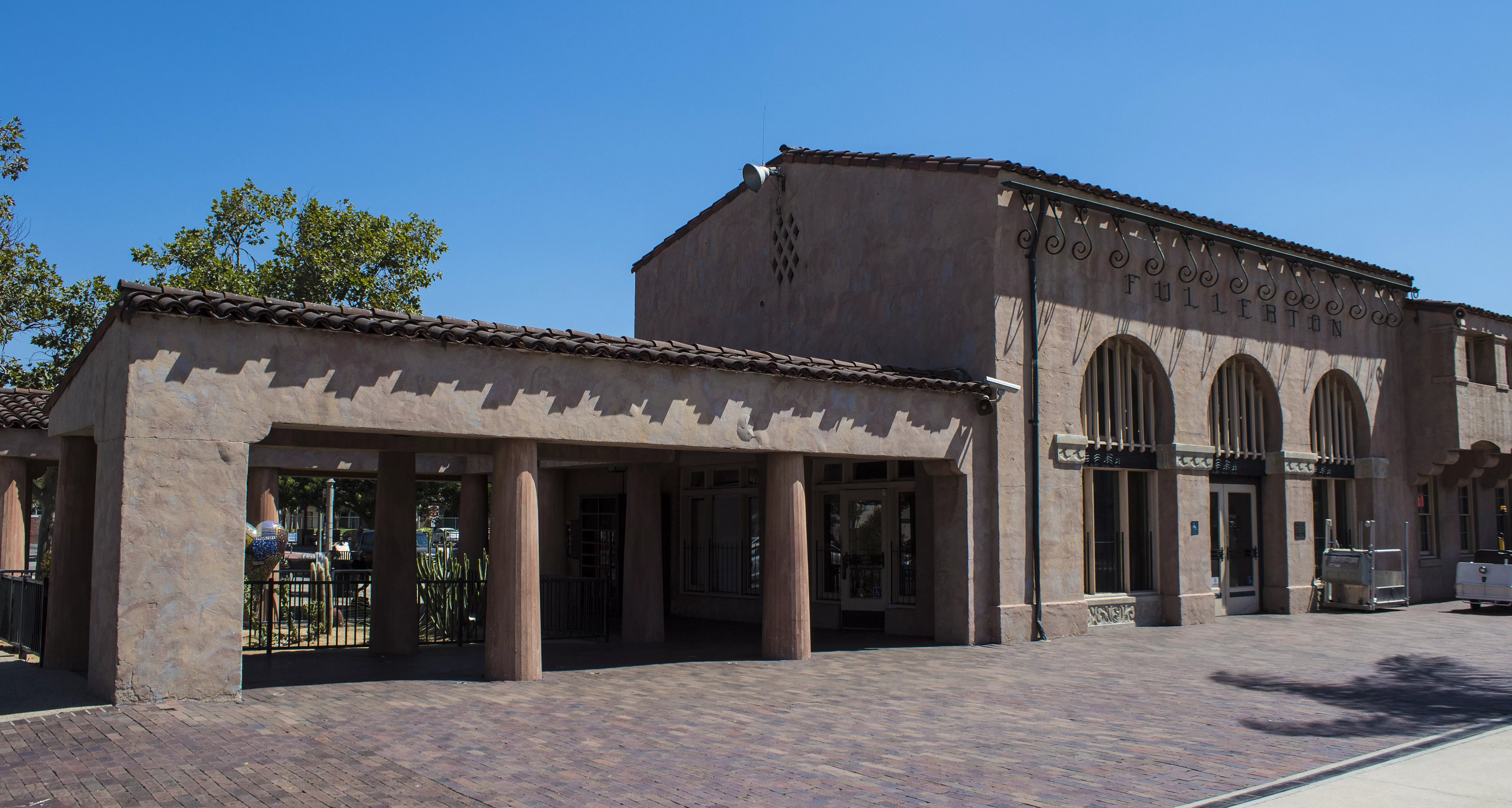 A colored photo of the Santa Fe Railway Passenger &amp; Freight Depot in 2017.