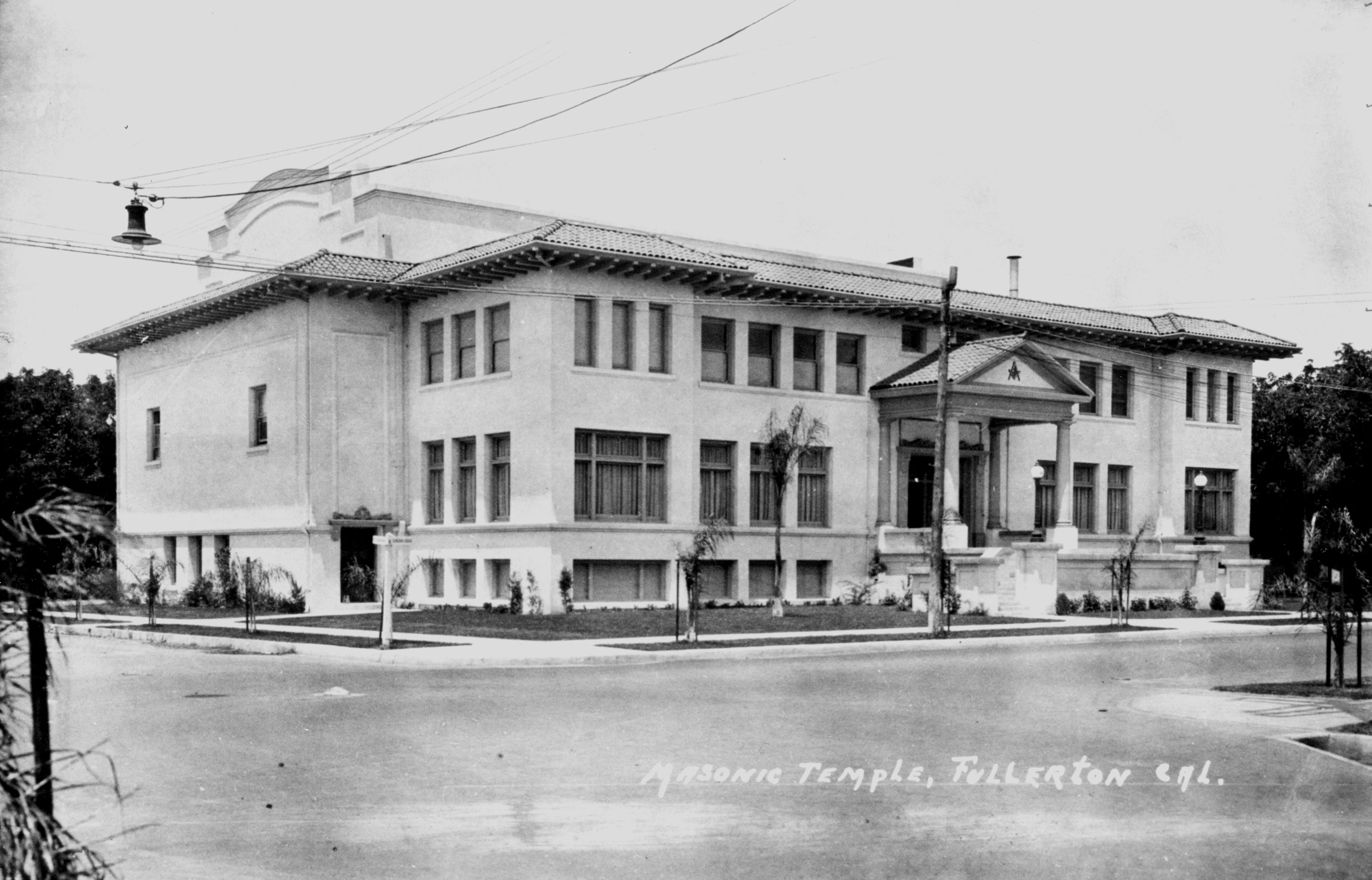 A black and white photograph of the early exterior of the second Masonic Temple in the 1920s. The bottom right corner of the photo reads: Masonic Temple, Fullerton, California.