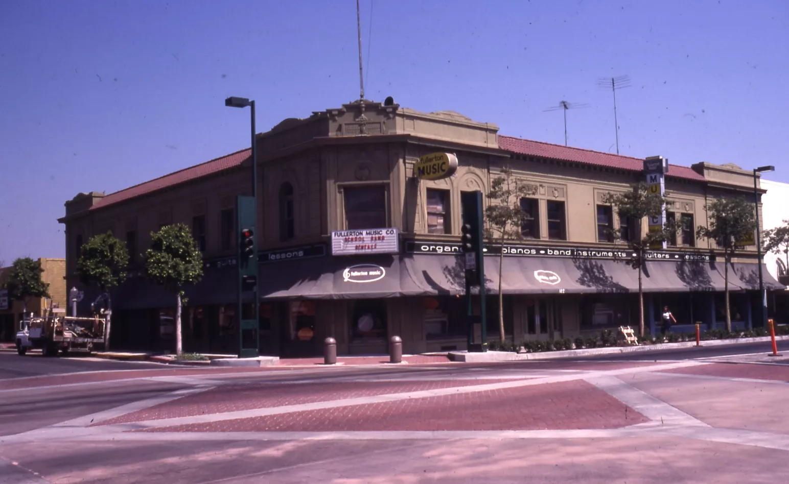 A colored photo of the Farmers and Merchants Bank during Fullerton Music in 1981.