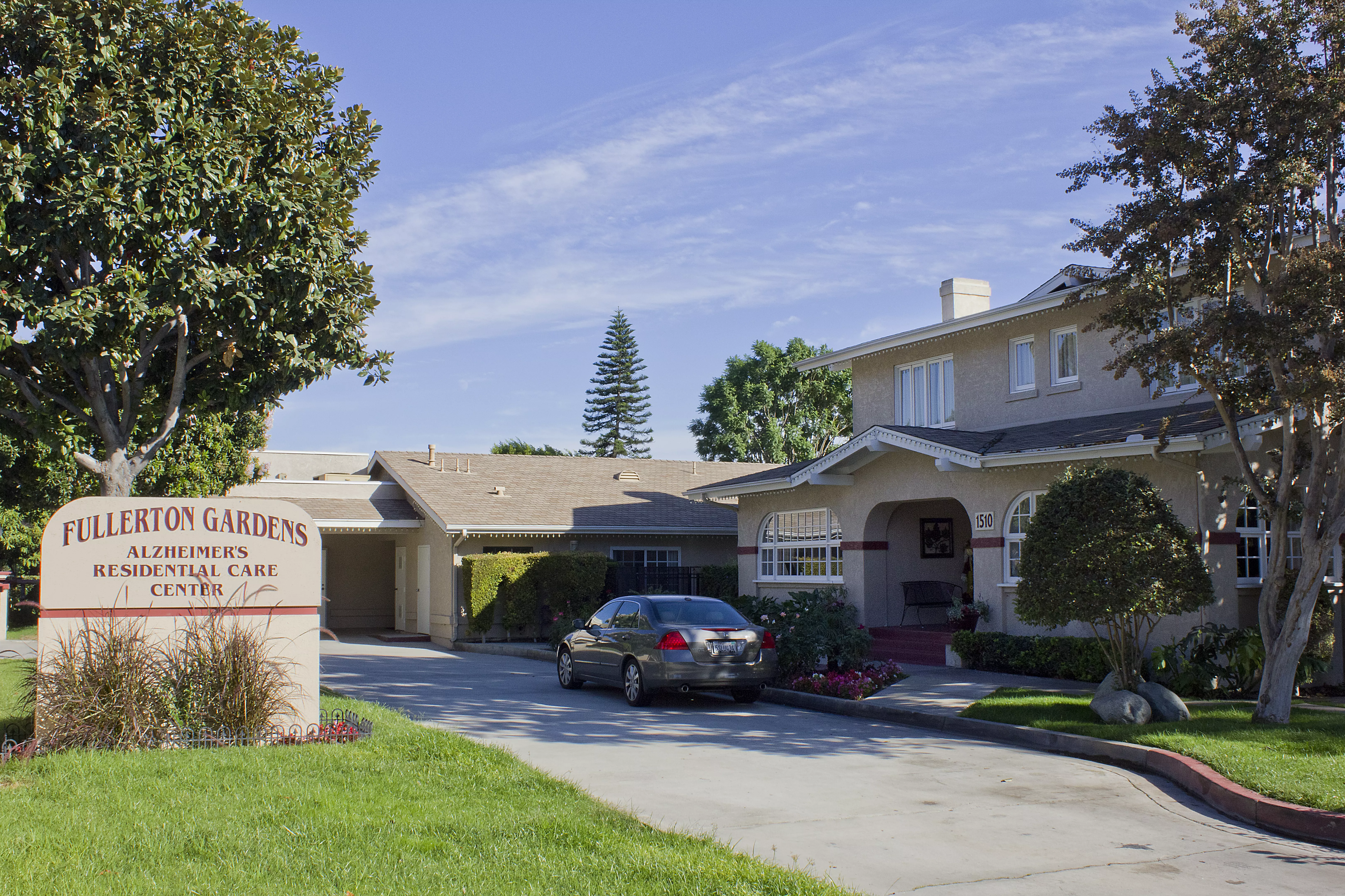 A colored photo of the Bert Annin House as a residential care center in 2012. The sign in front of the property reads: Fullerton Gardens. Alzheimer&#039;s Residential Care Center.