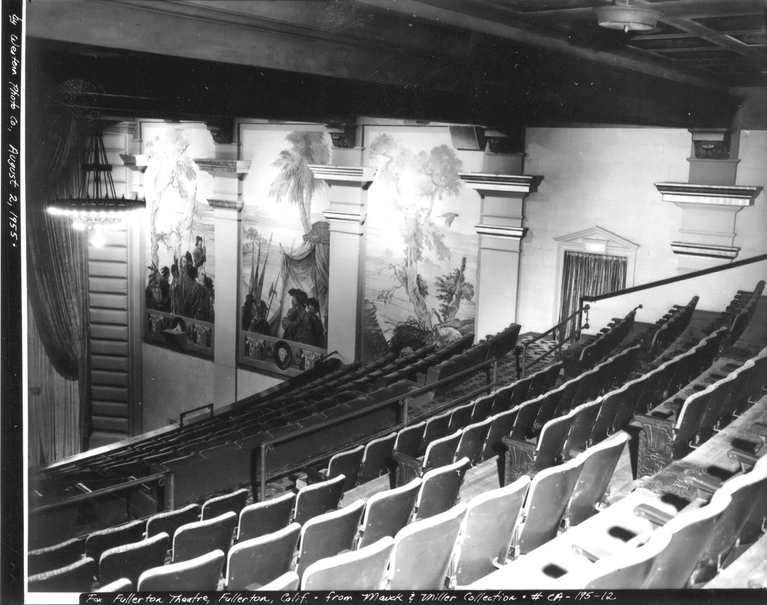 A black and white photograph of the interior balcony inside the Alician Court Theatre in 1955.