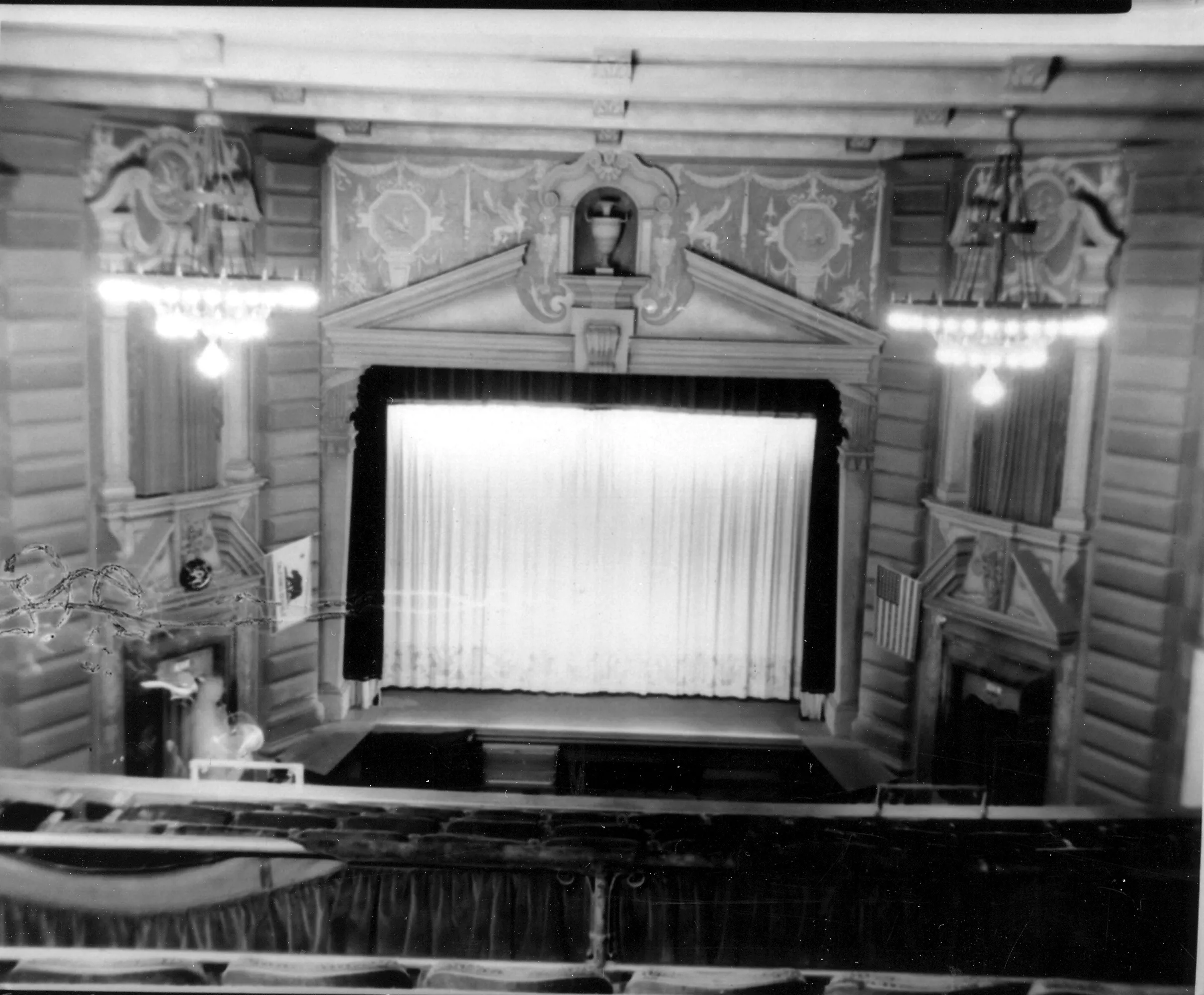 A black and white photograph of the Alician Court Theatre&#039;s screen from a balcony view.