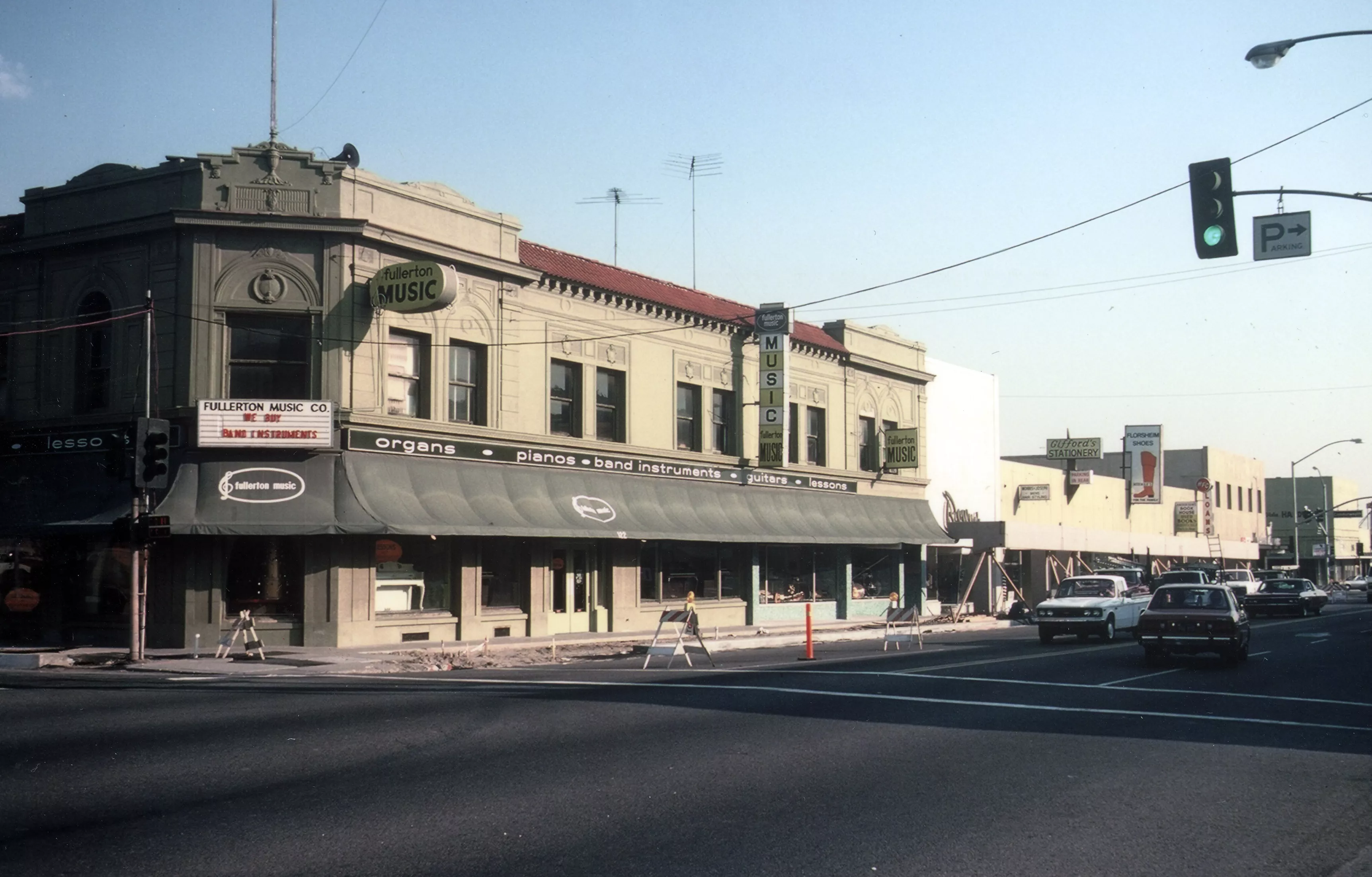 A colored photo of the street scene for the Farmers and Merchants Bank in the 1970s.
