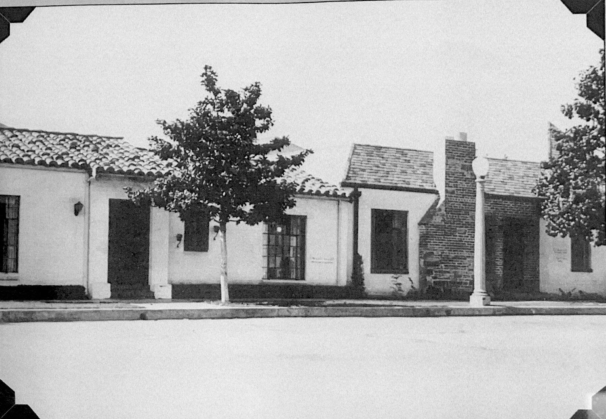 A black and white photograph of the Dr. Olson Home &amp; Medical Office after expansion.