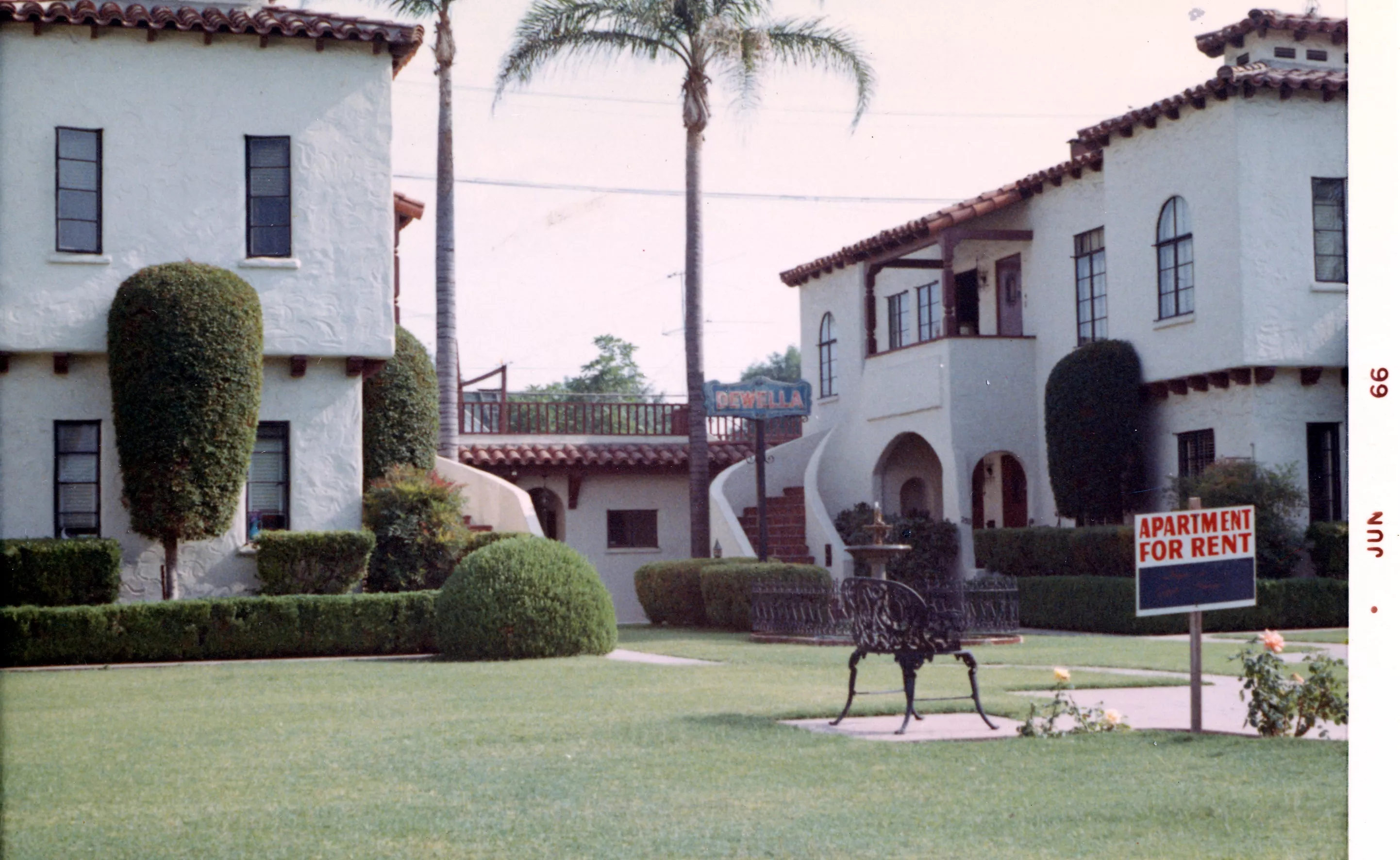 A colored photo of the exterior of the Dewella Apartments in 1966. The right side of the photo is dated June 1966.