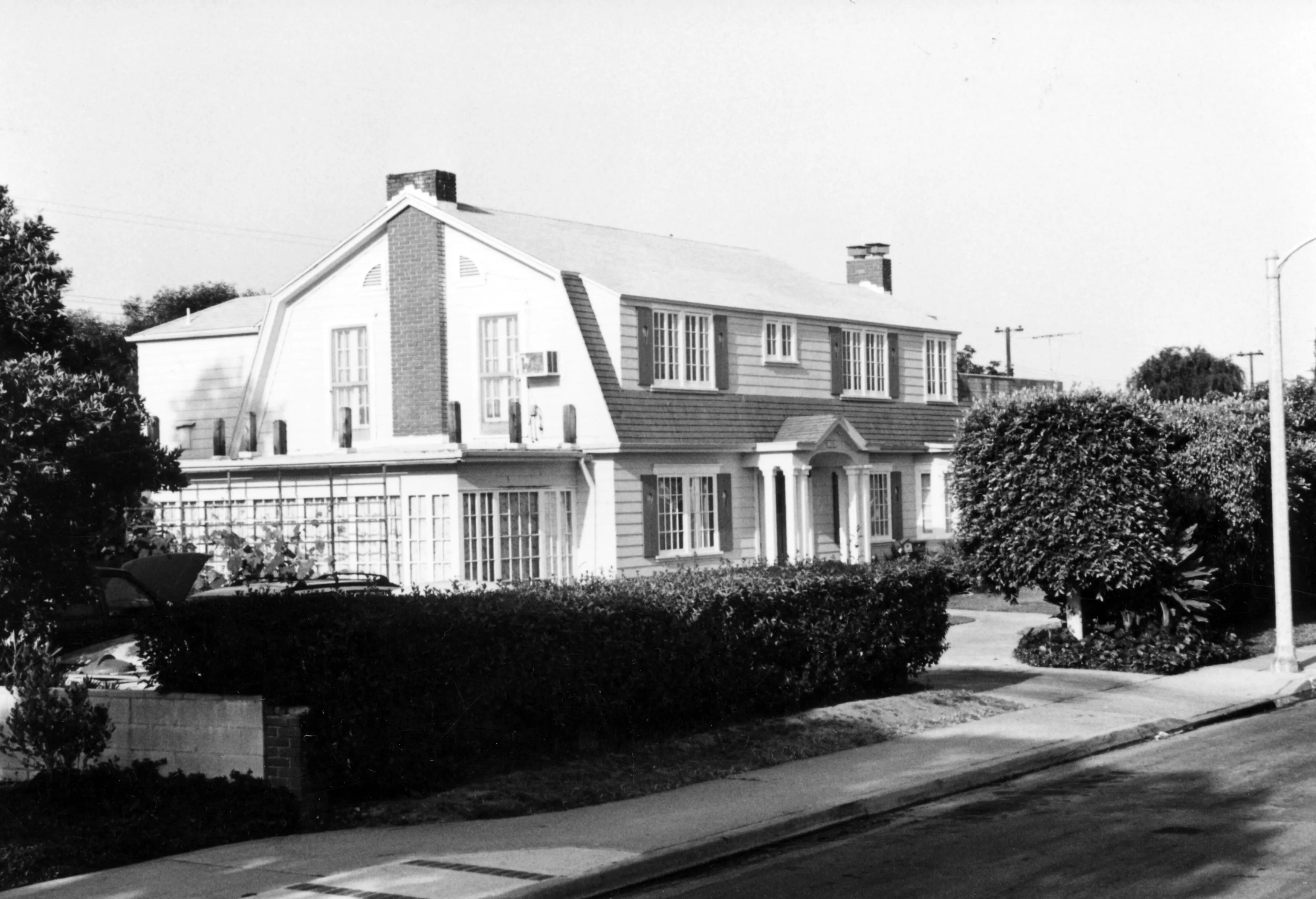A black and white photograph of the exterior of the Max Royer House in 1993.