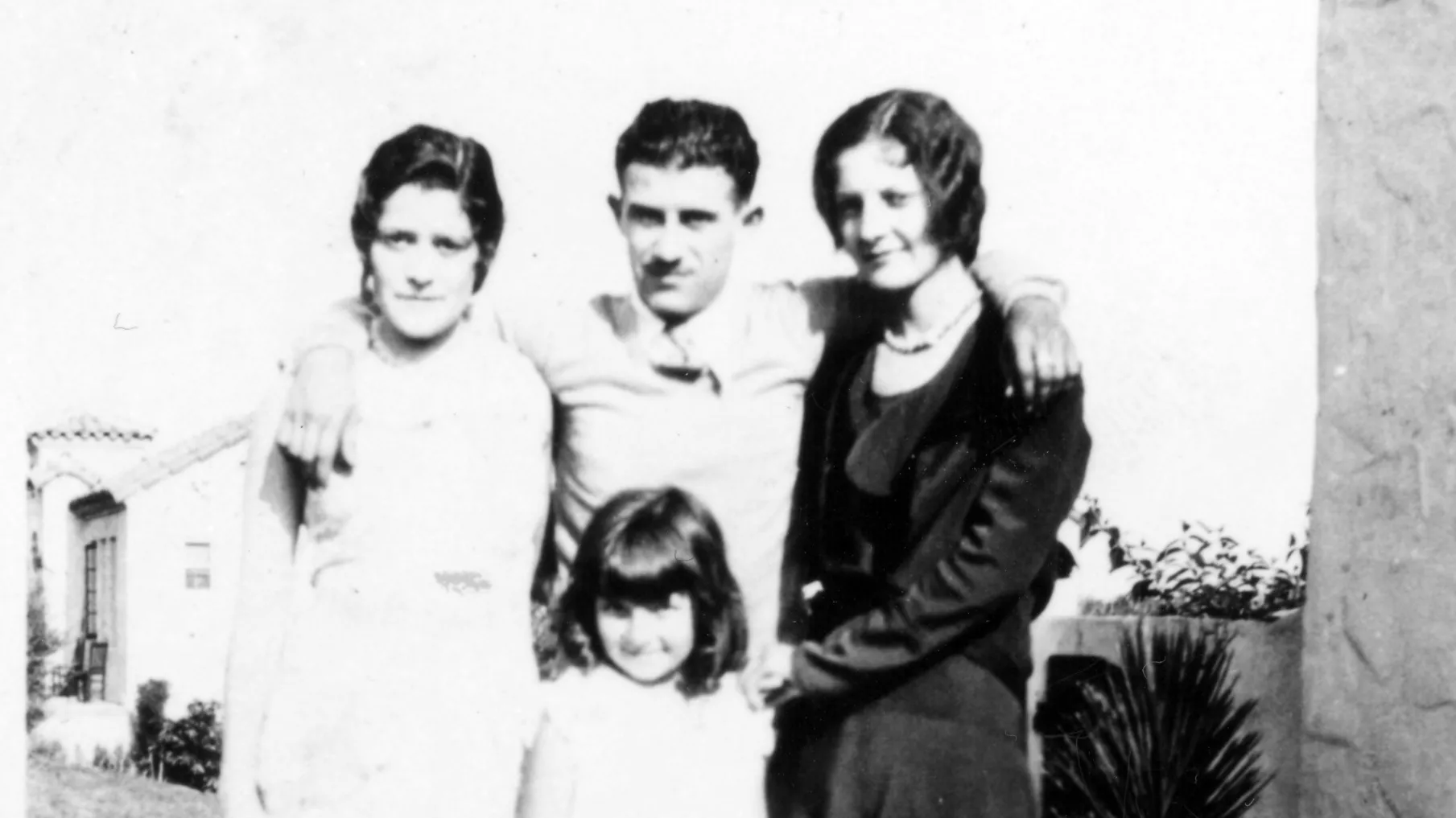 A black and white photograph of the Hirigoyen family standing on the lawn in the 1940s.