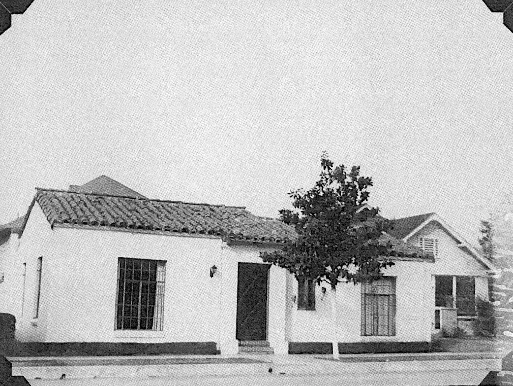 A black and white photograph of the original home remodel for the Dr. Olson Home &amp; Medical Office.