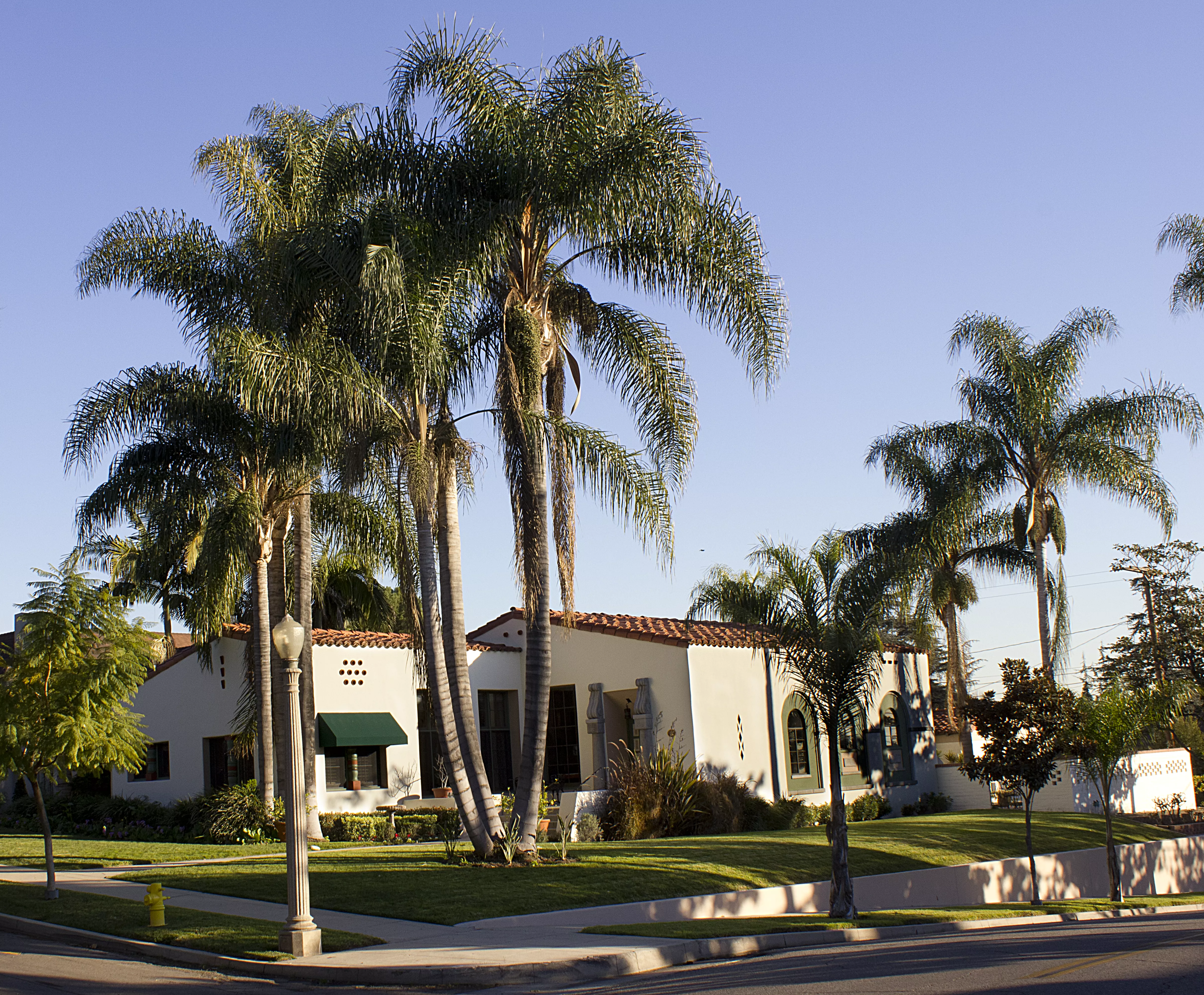 A colored photo of the street scene in front of the Hugh Edgar Johnson House in 2012.