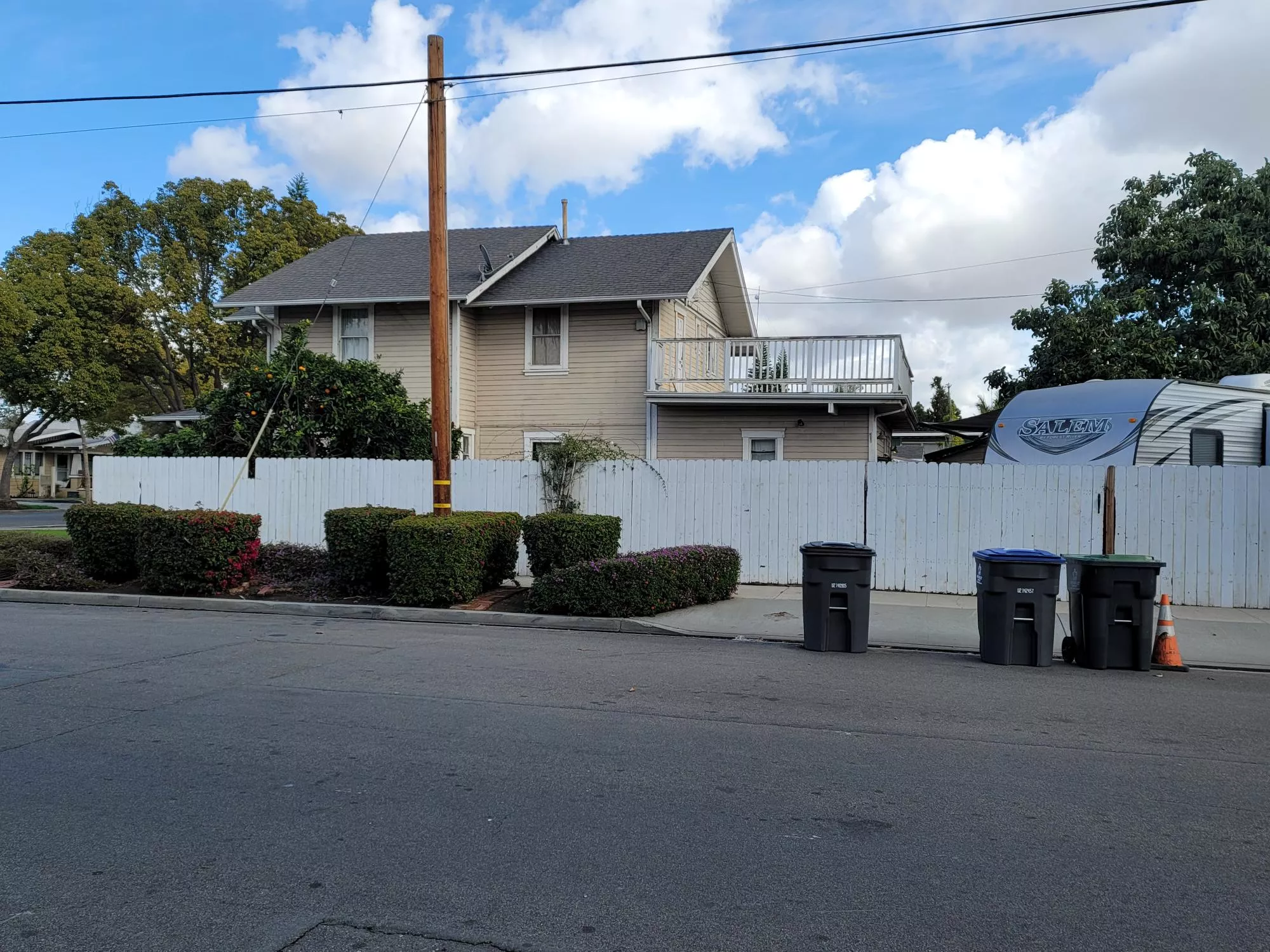 A colored photo of the west side of the Thomas Robertson House in 2025.