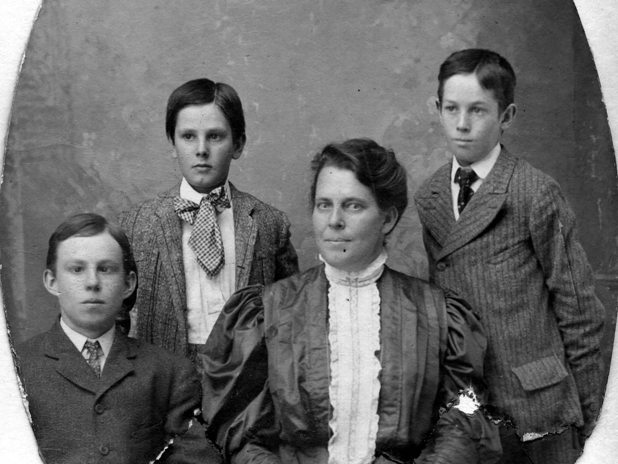 A black and white portrait photograph of Carrie Ford and her three sons.